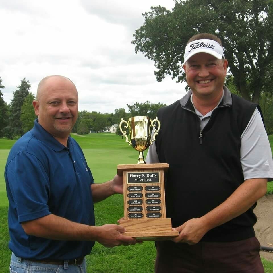 men's club president tony simon presents the winner's trophy to eric przybyla