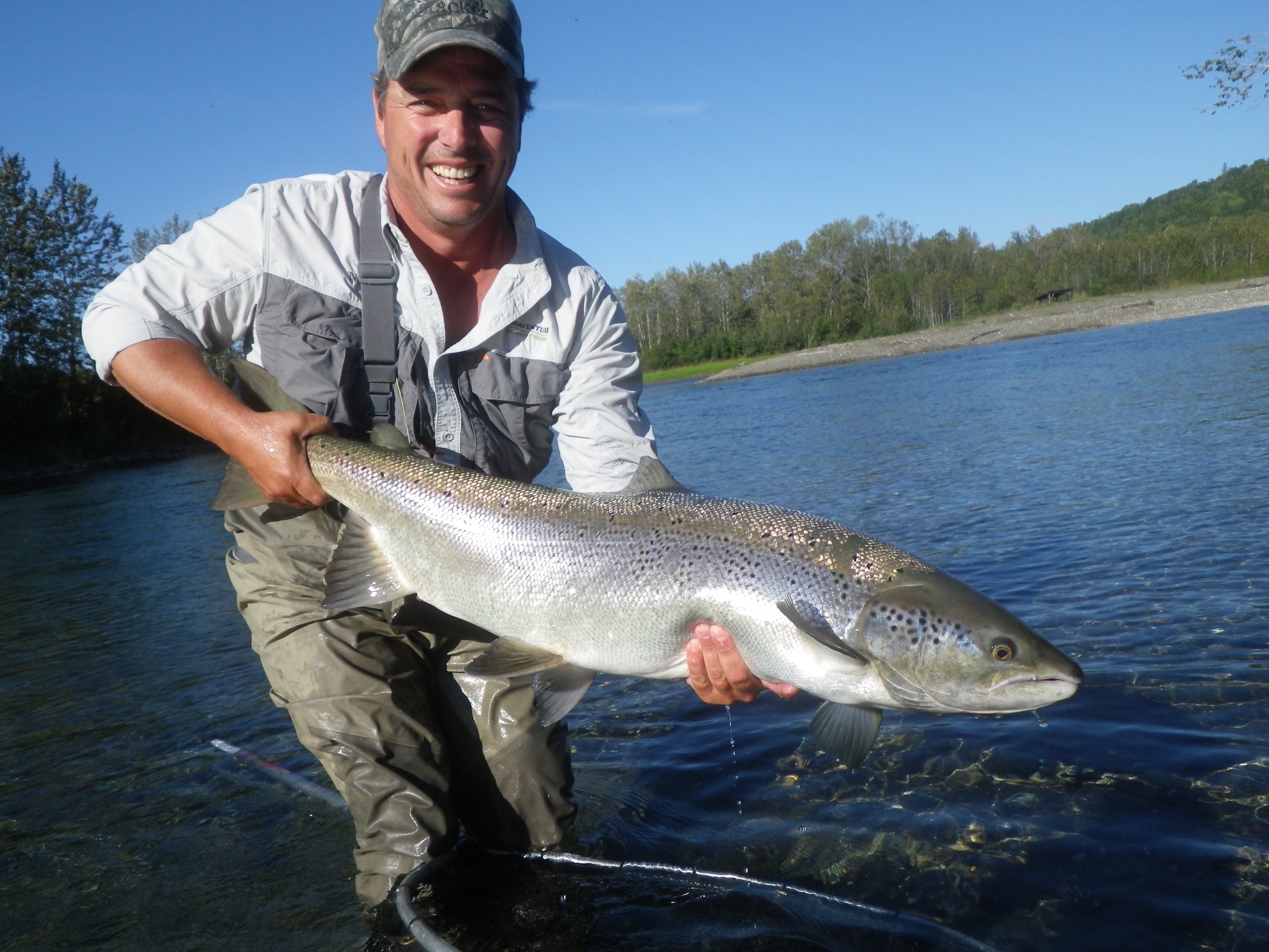 Camp Bonaventure guide Matthew Flowers with a nice one on the Petite Cascapedia, needless to say he had a happy fisherman!