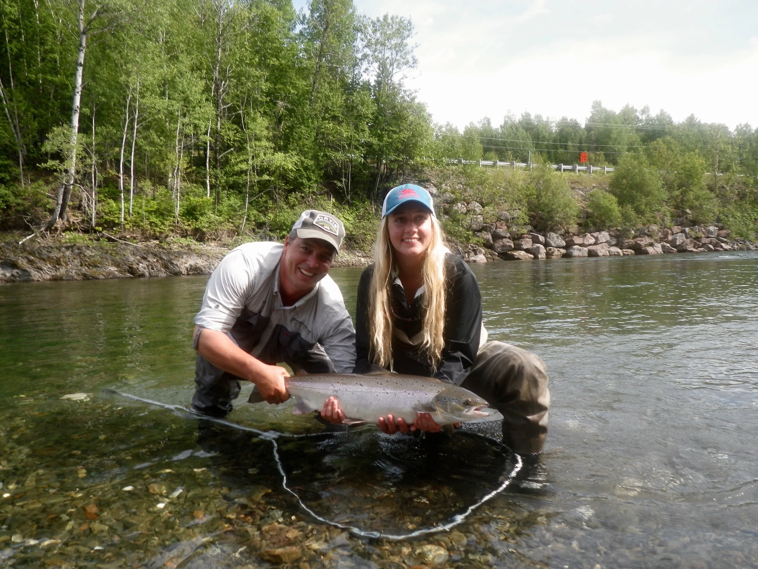 Camp Bonaventure guide Matthew Flowers helps Delainy Simchuck release her first Atlantic Salmon, Congratulations Delainy!