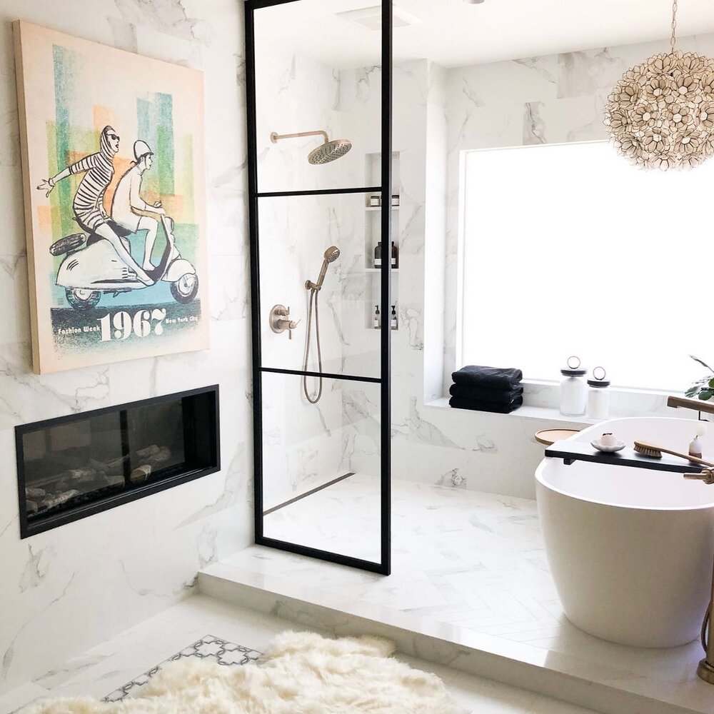 One of our favorite views 🙌 
.
working with a tight space and angled walls was a challenge to get the right layout for this bathroom. Clients wanted a bigger walk in shower, a soaking tub, double vanity, make up vanity, keep the fireplace, separate 