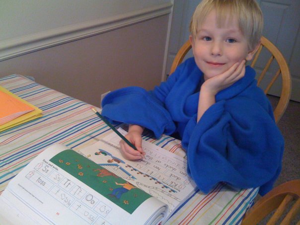  My favorite home school picture ever. Our middle child doing Kindergarten in a Snuggie.
