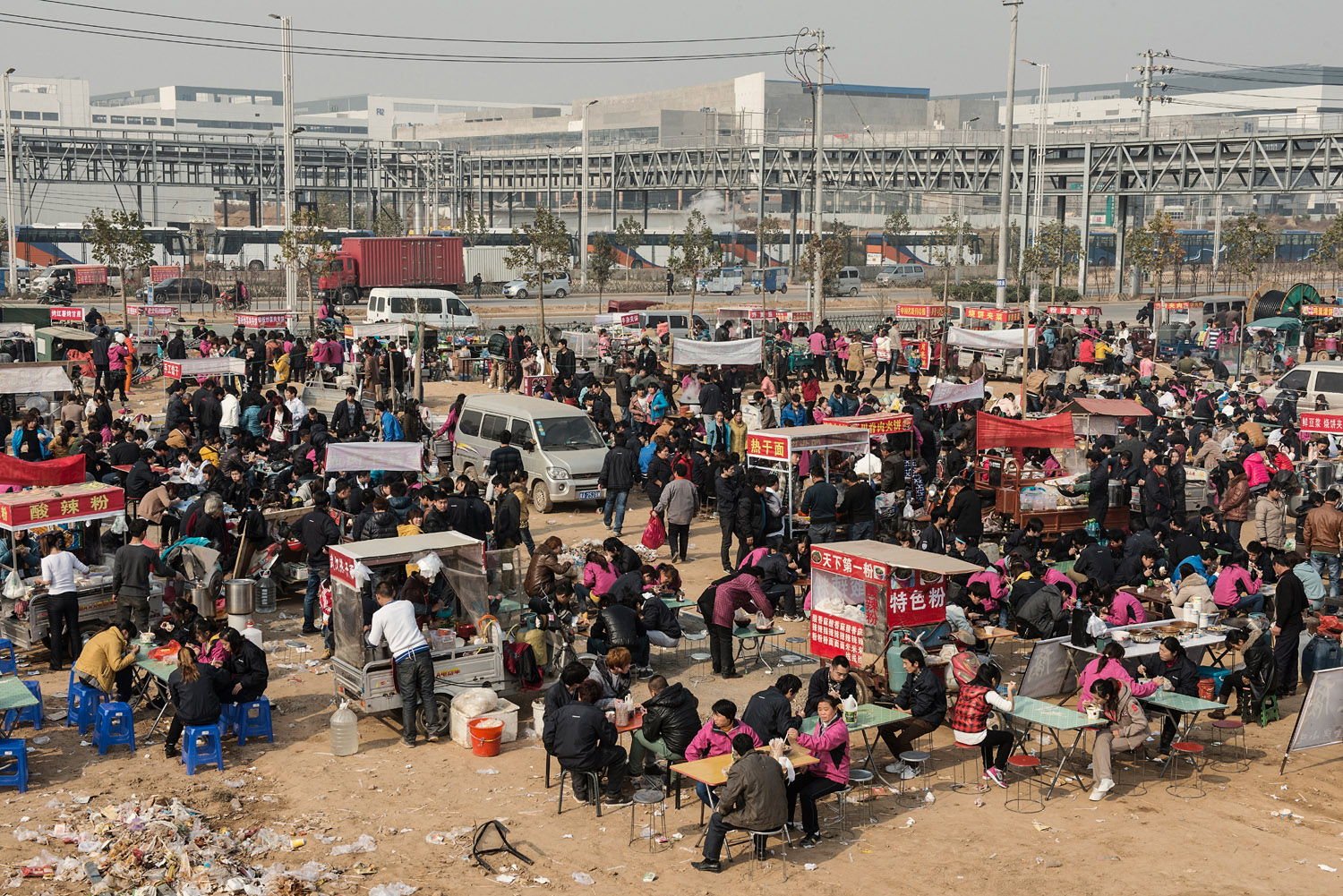 At lunch break hundred of factory workers have left the factory to have food at the stalls which are catering to them. Foxconn provides food for its workers but many of them prefer to eat out because, they say, of the poor taste/quality of the one provided by their employer.