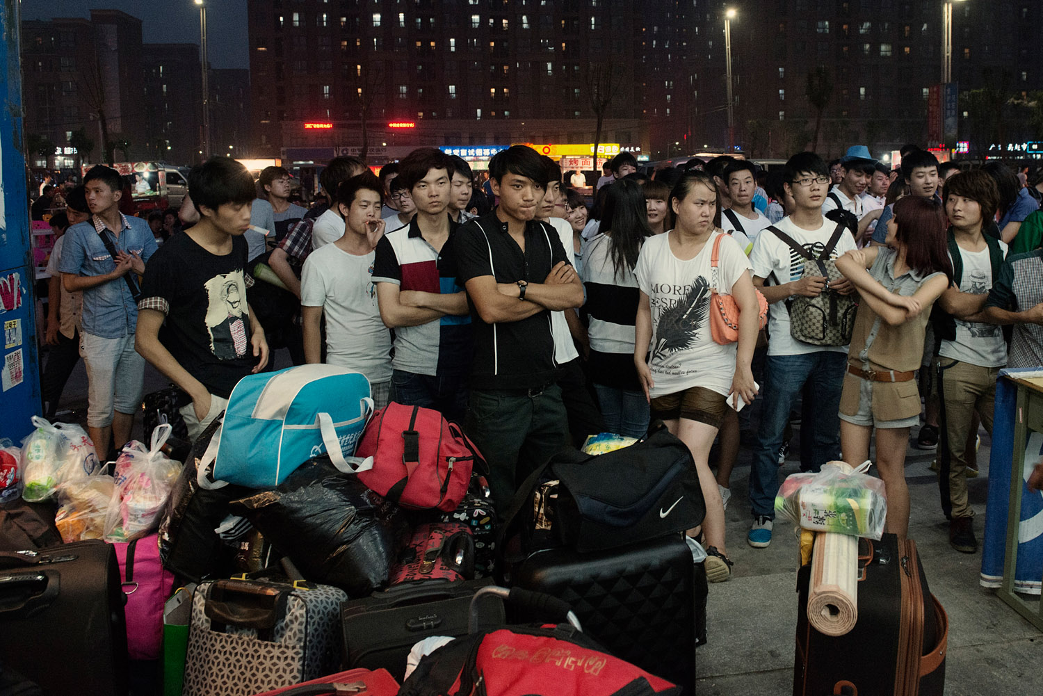 Just hired Foxconn workers are waiting for the agent who recruited them. For hiring workers, Foxconn relies on the provincial government which itself subcontract agents. The turnover is high at Foxconn and agents are almost constantly hiring.
