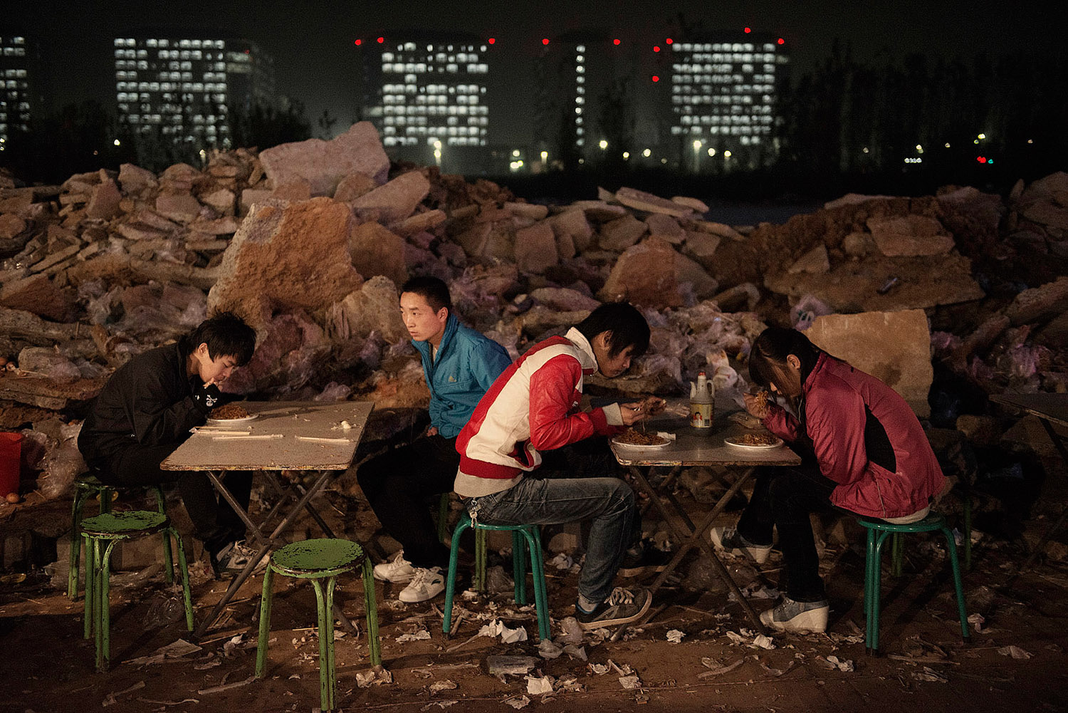 Foxconn workers having dinner in a small outdoor restaurant in front of their dorms.