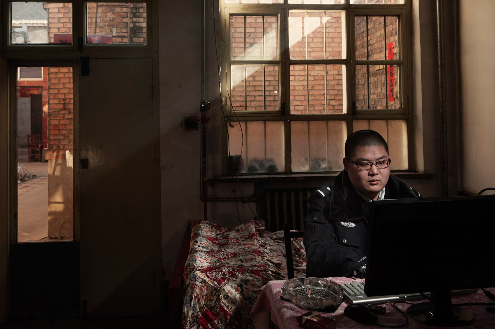  Xiangyuan (Shanxi) January 24, 2012.Li Ke a prolific author of online novels, in his room where he spends hours every day writing. Li runs a double life: policeman during the day and writer when he is not on duty. (For Time Magazine) 