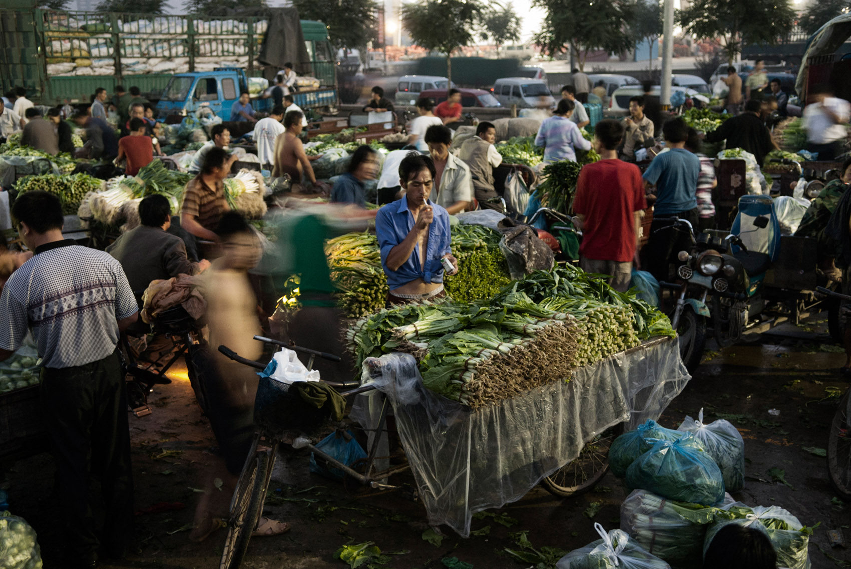 A vegetable seller lights a cigarette at dusk, in Beijing. China has 350 million of smokers out of which 1,3 die each year of tobacco related diseases. The tobacco industry is State controlled with its major holding, China National Tobacco Cor