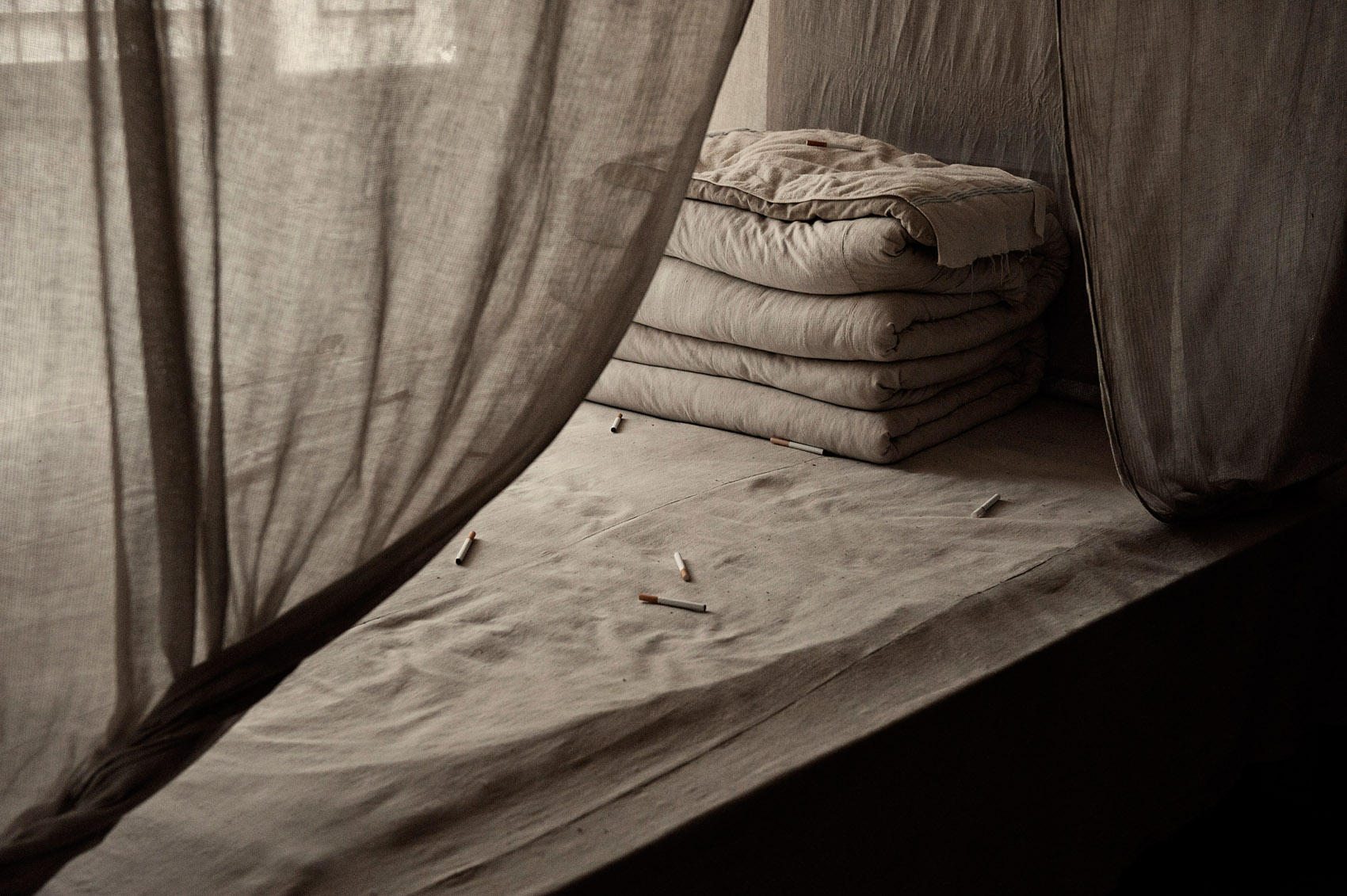 Visitors have thrown cigarettes on a bed where Mao allegedly slept when he was living in Yan'an. 