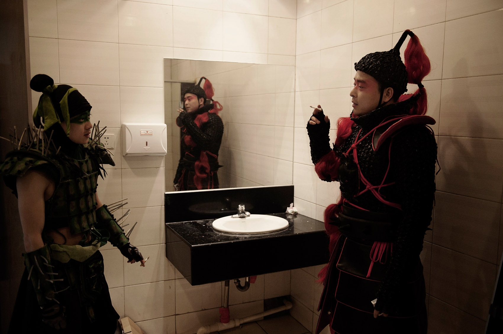Actors smoking in the toilets during a break on a movie set. Laws have been created to restrict smoking in public places but they are rarely enforced.