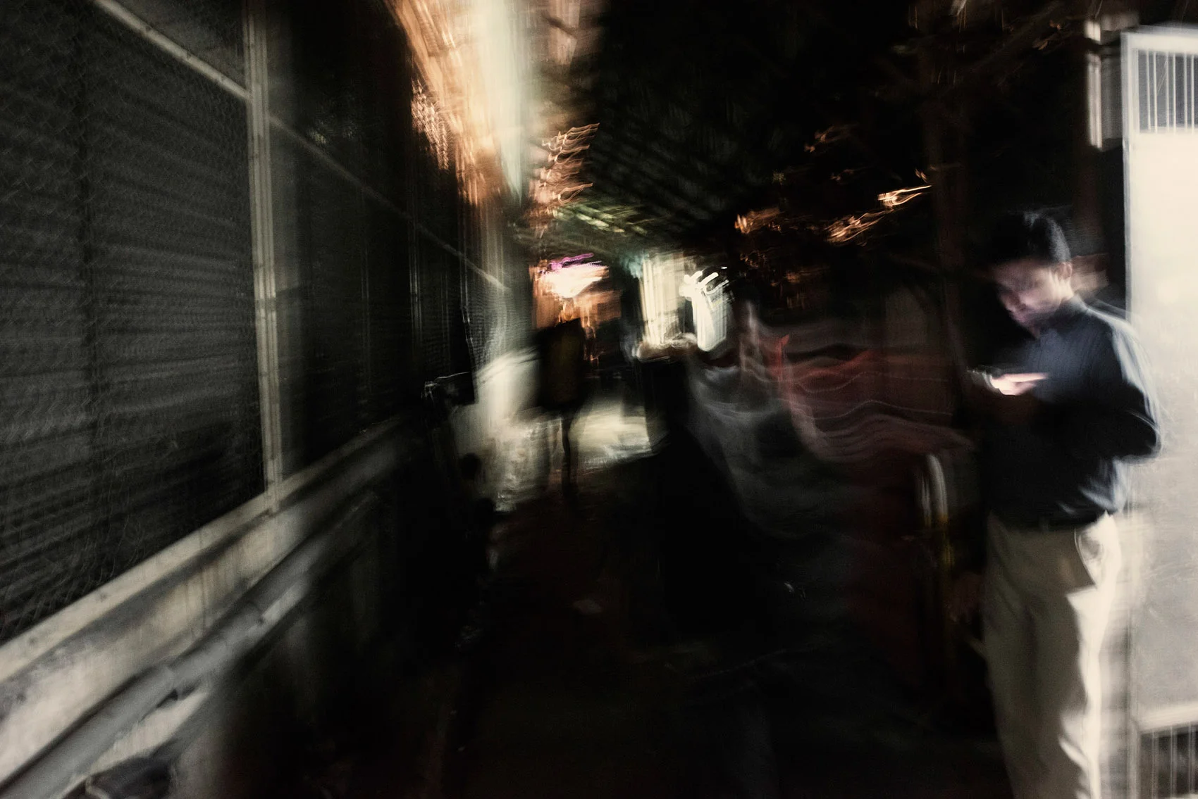 At night a side alley of the Chungking Mansions.
