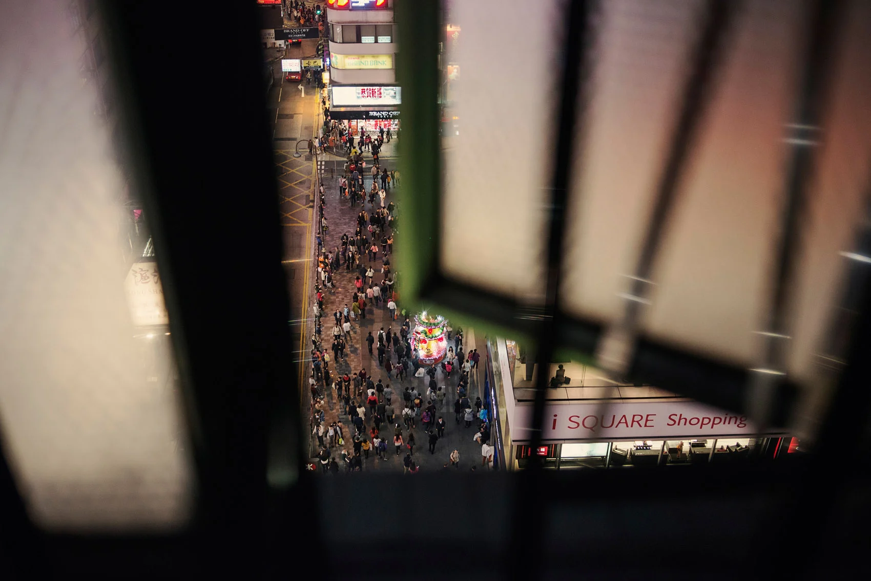 A view on a busy street of Hong Kong through the bedroom window of a Chungking Mansions guest house.