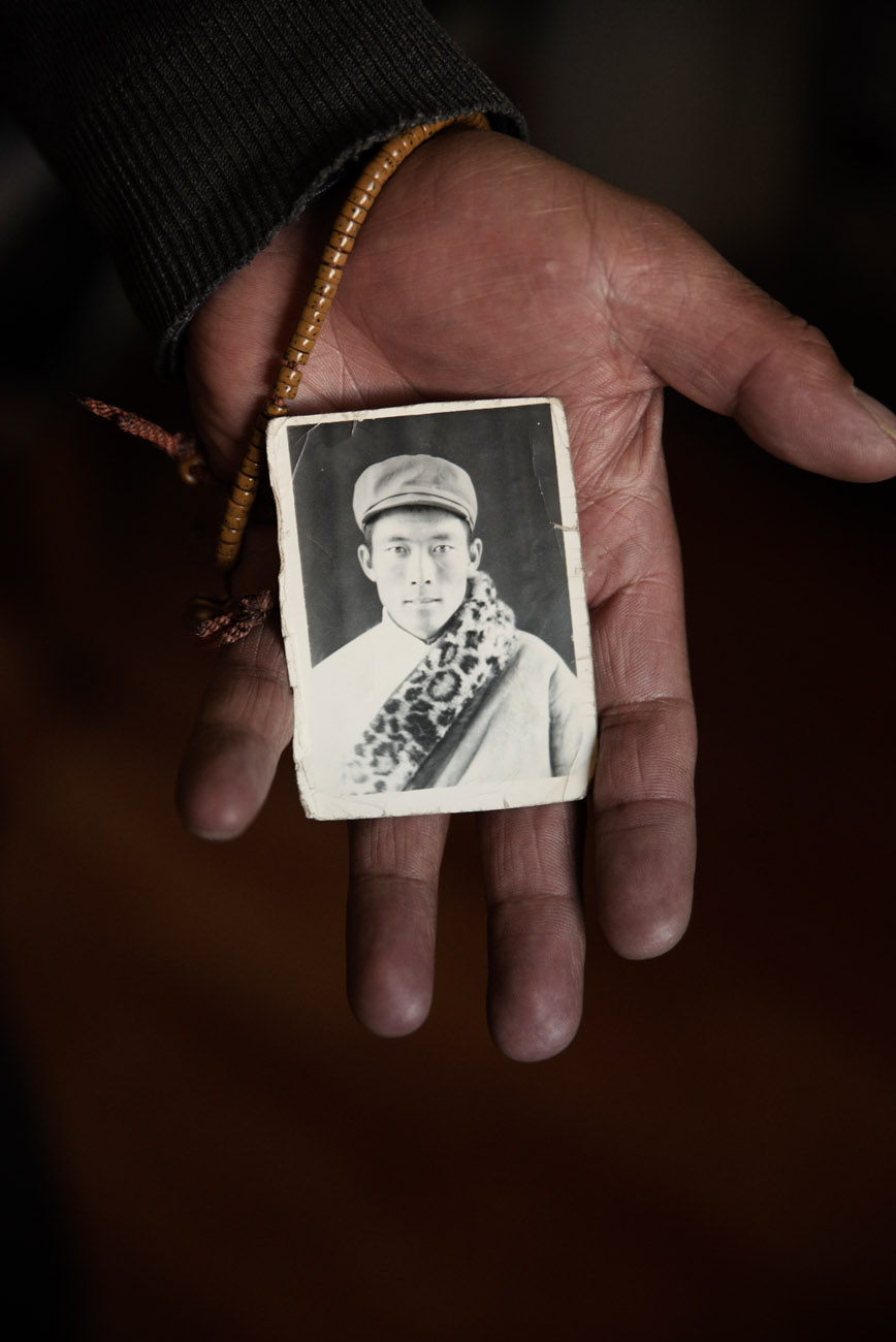 A Tibetan nomad, showing a picture of himself at the age of 25. A nationwide campaign of nomad resettlement, in the name of environment protection is pushing Tibetan to give up pastoralism for a sedentary life alien to them.