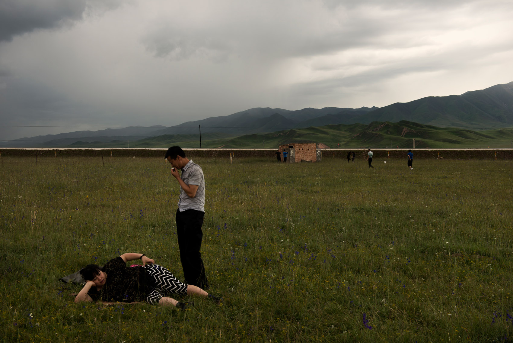 Chinese tourists enjoying the Tibetan grassland near Xiahe (Gansu). Some Tibetan nomads in the region have set-up camps for tourists, cashing on the fascination for nomadic lifestyle.. A new source of income for them as their livelihood is under threat by a resettlement plan. 