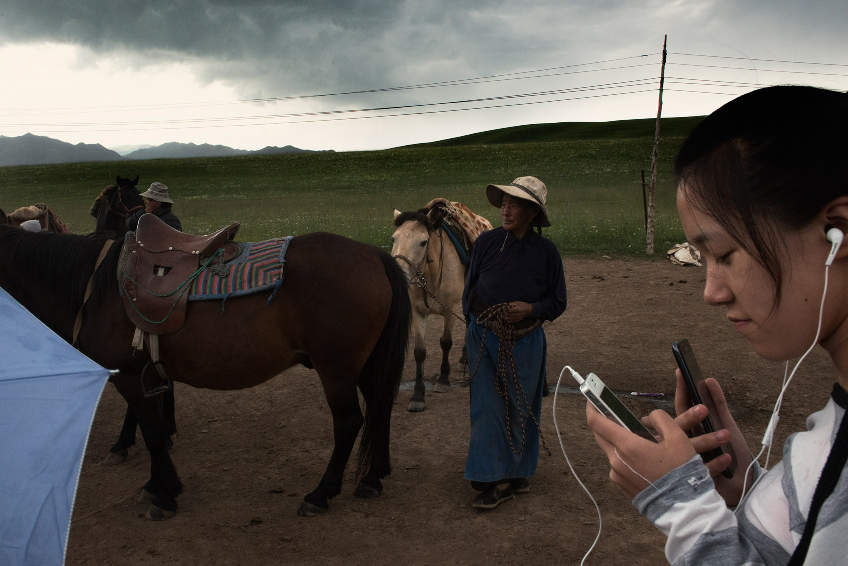 A Chinese tourists at a horse-riding camp set-up by Tibetan nomads in the grassland near Xiahe (Gansu). Some nomads in the region have set-up camps for tourists, cashing on the fascination for nomadic lifestyle. A new source of income for them as their livelihood is under threat by a resettlement plan. 