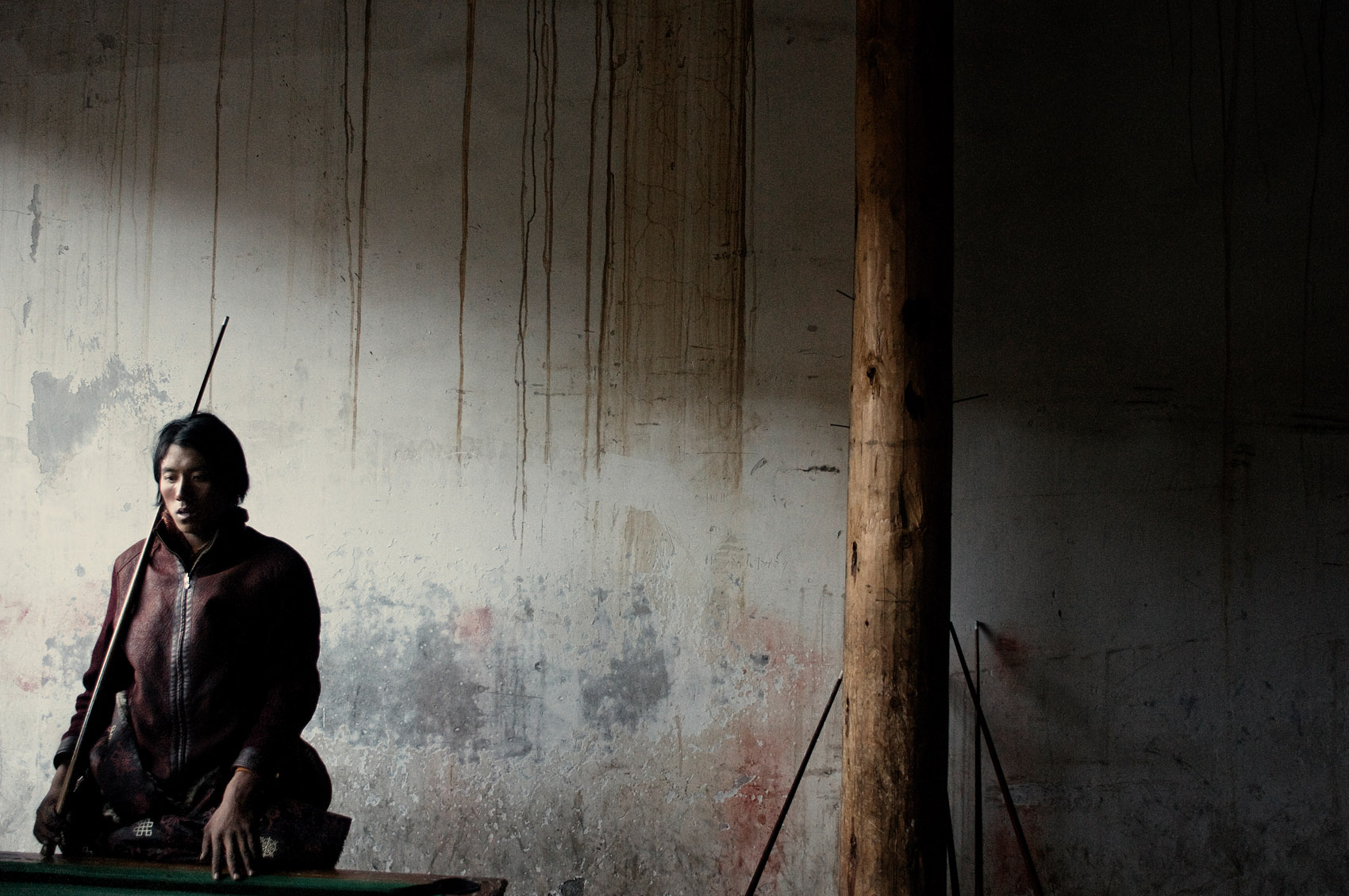 A young nomad playing pool. Forced to give up herding, it is difficult for nomads to find alternate source of income. With little education, no professional training, and no job market, many nomads live on the government compensations until they dry up and then leave the grasslands.