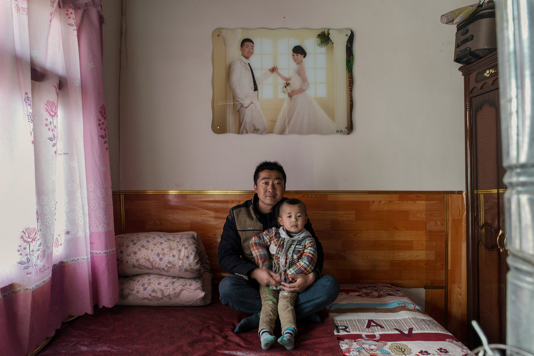 Anyuan Village 32 years old Niu Binggui, with his three years old son Niu Haoran Niu Binggui is a cook for a construction company in Ningxia province several hundred kilometers away from the family hometown. He is now is own boss in charge of the catering for a construction site. It means a little more money but also more responsibilities. For 10 years he has been working as a cook in restaurants and dreams of opening his own, but lacks the funds to do so. In two day he will be leaving for work at the end of his new year break. He won't see his family again before months. 