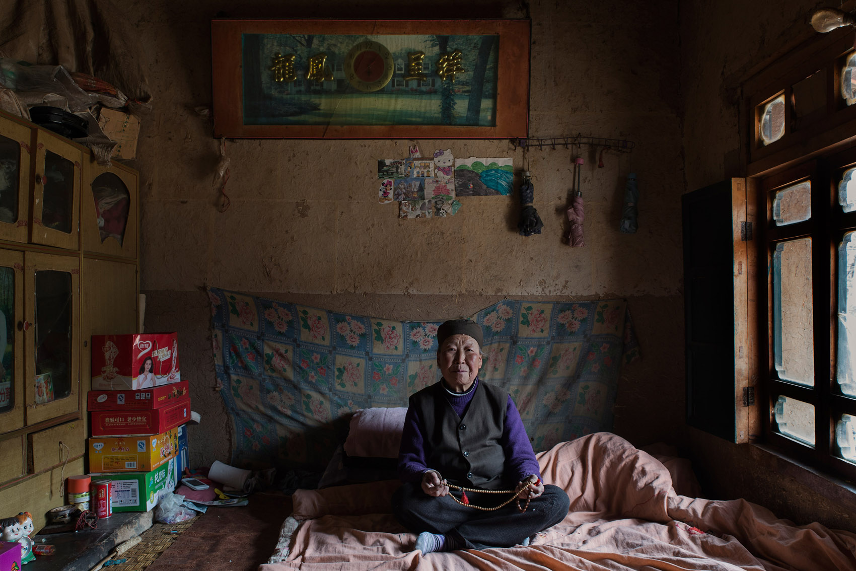 Baijiawan village 73 years old An Shoujia. An is a strong believer in Buddha and thinks he is helping her with her ailments (back pain). Her husband was working in the fields when this picture was taken.