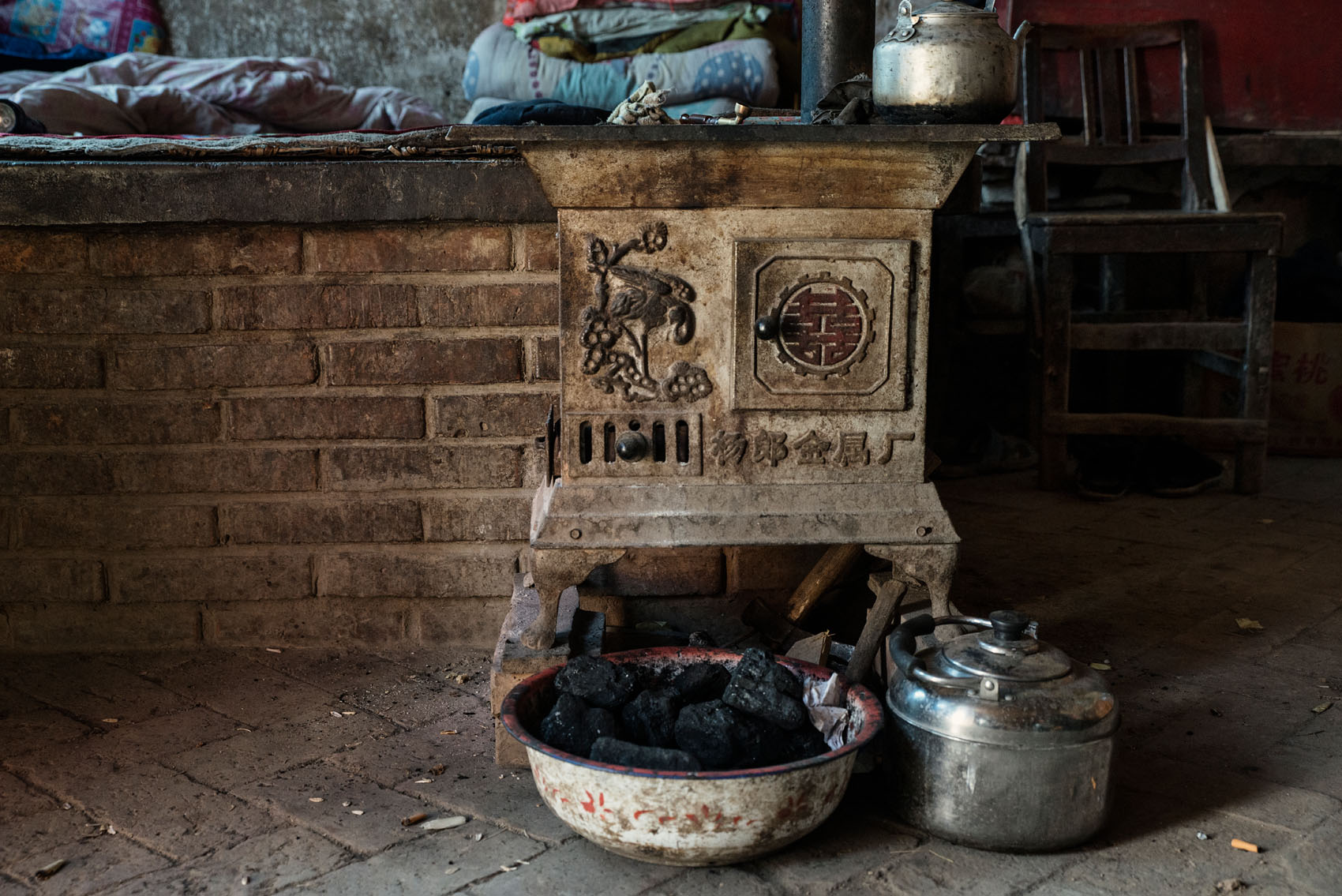 The coal burning stove next to Zhang's kang.