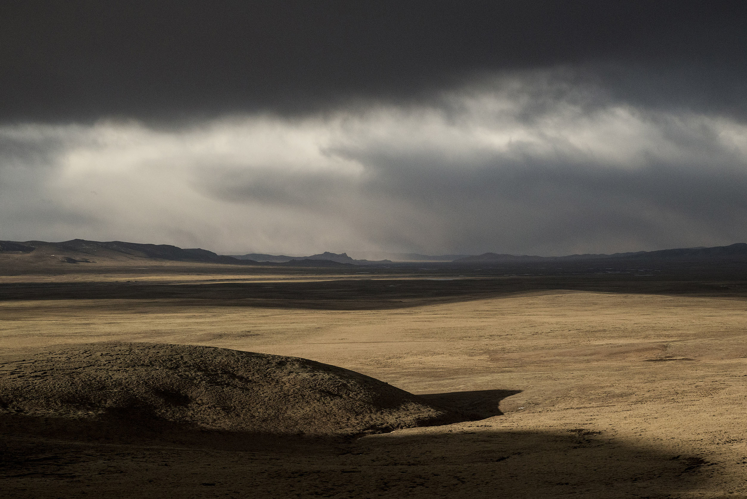The empty grasslands of the Three Rivers Park on the Tibetan plateau. Grazing is banned in thousands of square miles of this region and nomads are nowhere to be seen. A policy implemented in the name of environment protection, but increasingly challenged by scientists who argue that the threats to the Tibetan plateau ecosystem are the results of climate change, the proliferation of rodents, and pollution from mining activities rather than nomadic pastoralism which is actually beneficial to the soil. 