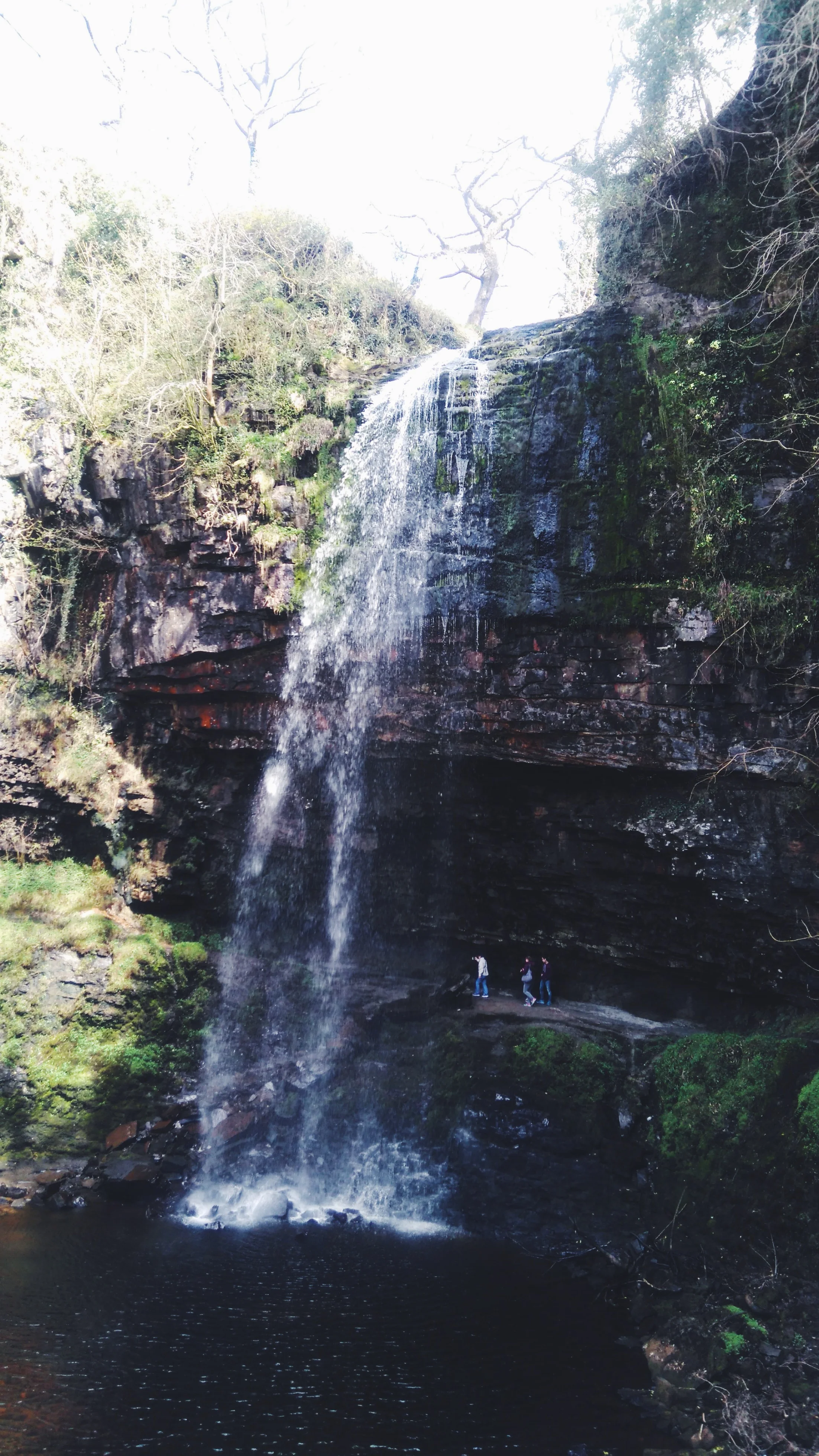 Real Wales Tour guests exploring Henrhyd Falls in the Brecon Beacons