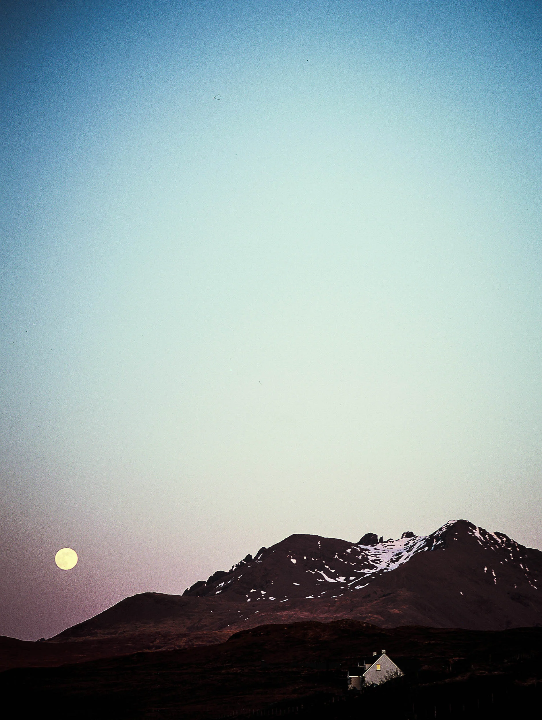 Moonrise over the Cuillin Mountains. I had my husband stop at the top of a cliff road with no shoulder so that I could climb on top of the car to get this shot. This was also my first time shooting slide film (which is really tricky), but glad I took the chance.