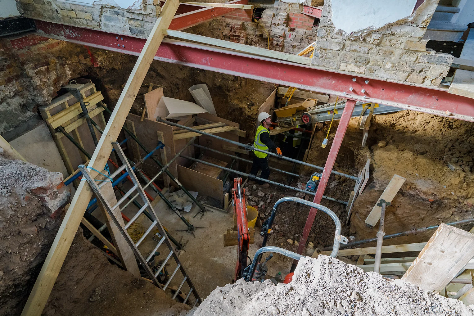 A builder checks on the conveyor belt that will mechanically lift out tonnes of rubble from the Meeting House and into a skip waiting outside