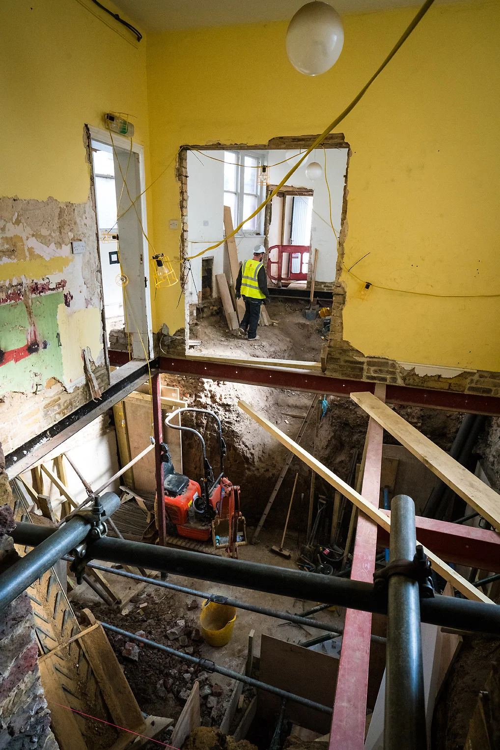 Team member moves through the extensive building works at the back of the Newington Green Meeting House