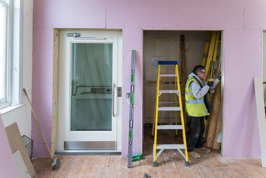 The new lift is framed by the partition wall being installed in the Mary Wollstonecraft room.