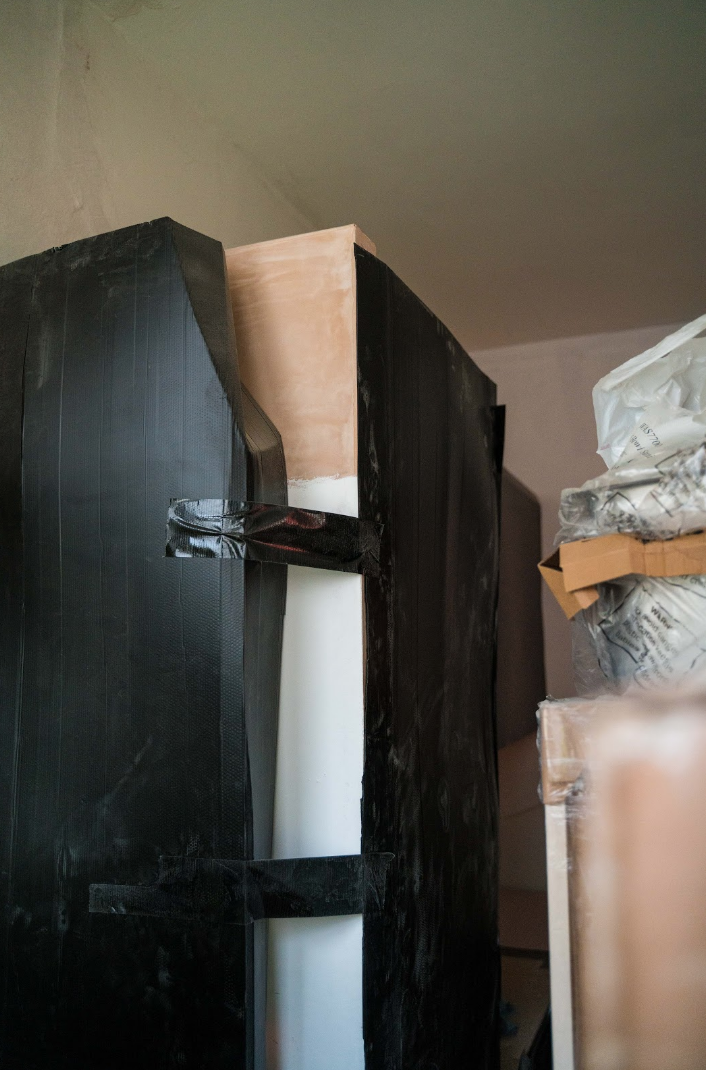 Kitchen appliances still in their packaging for protection waiting to be installed in the kitchen.