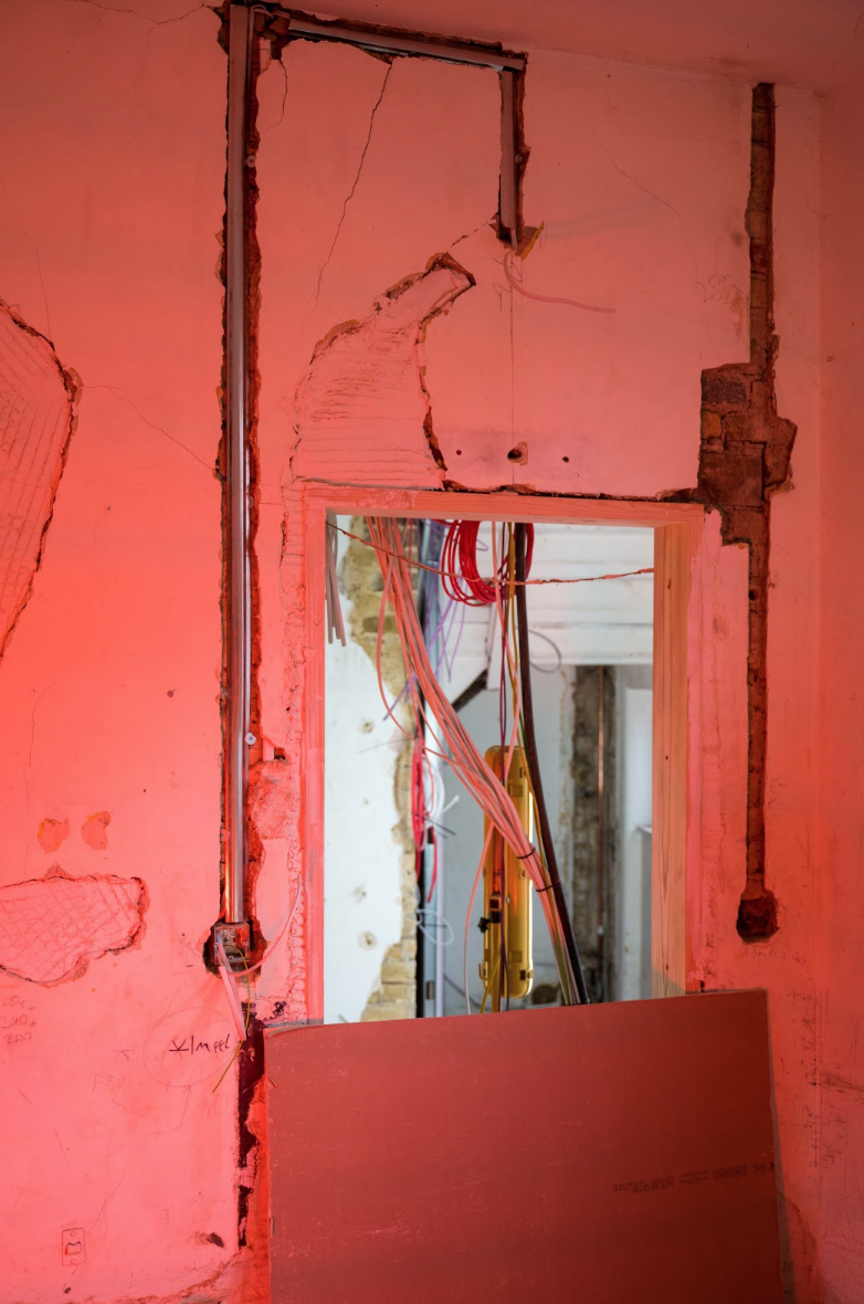 The last moments of open scars illuminated by the red glow of an electric heater.