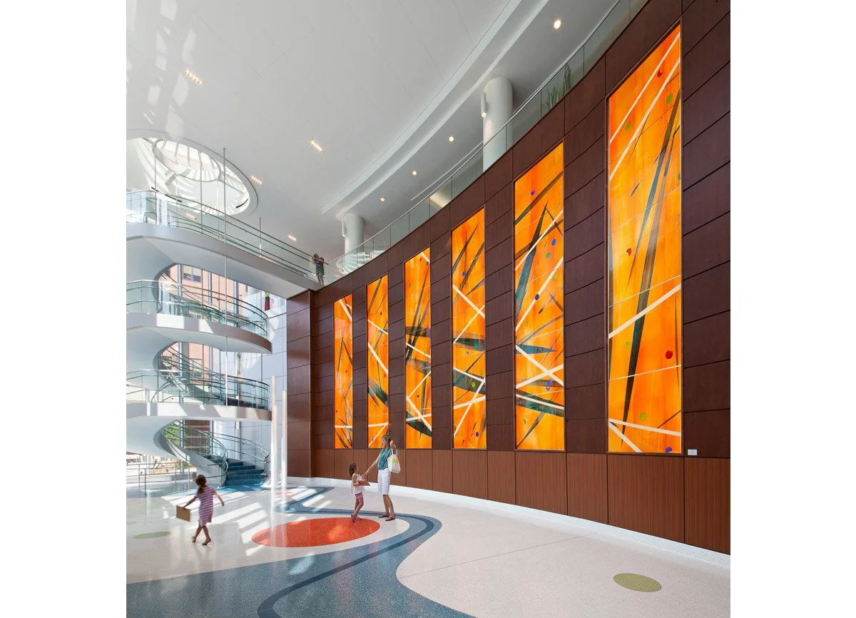 Large-scale hospital lobby feature art backlit glass wall