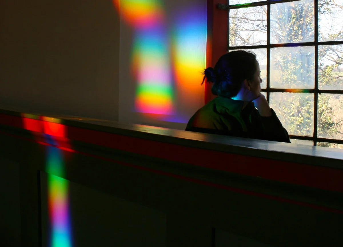 Woman bathed in rainbows
