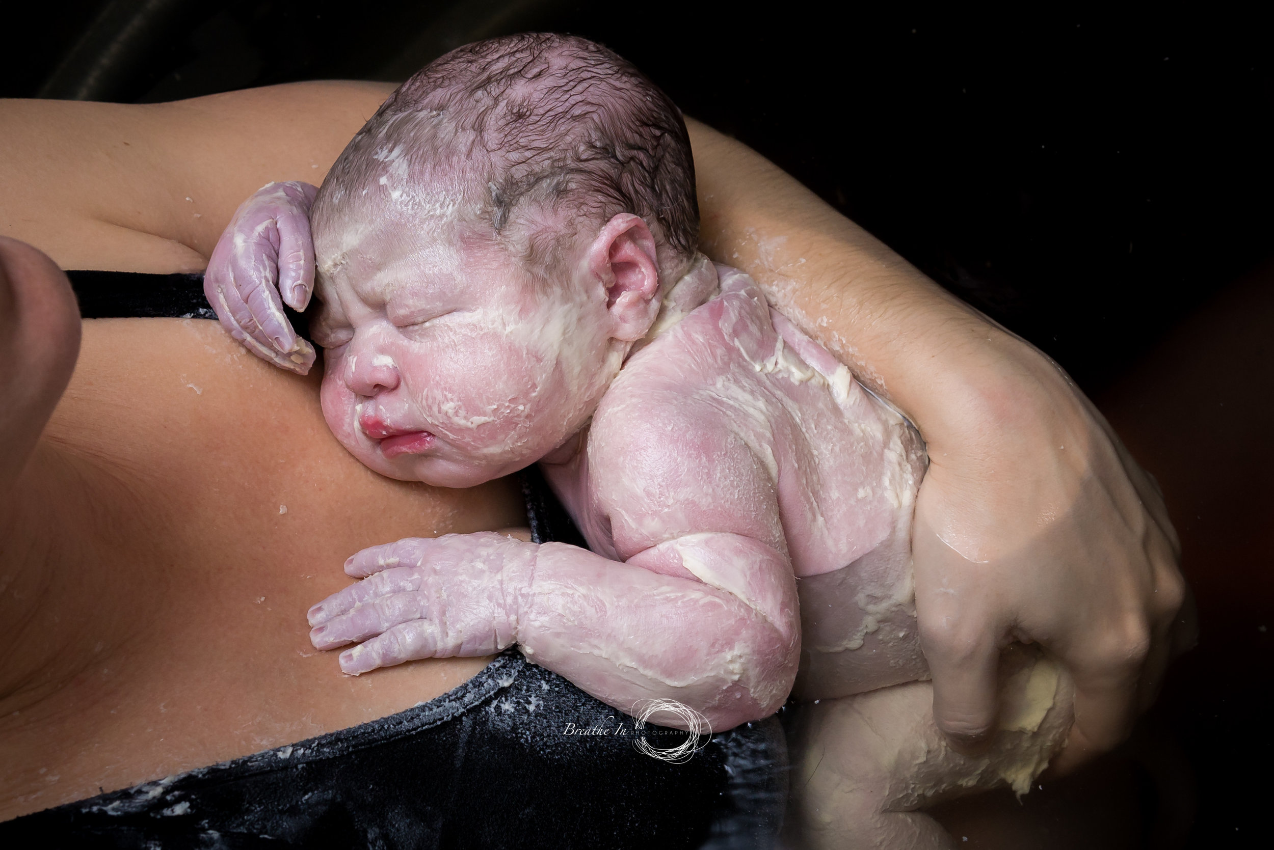 This beautiful girl was born covered in vernix. Vernix is a sticky waxy substance full of protective elements for baby - left on it will soak in in about 24 hours. Image by: Breathe In Photography