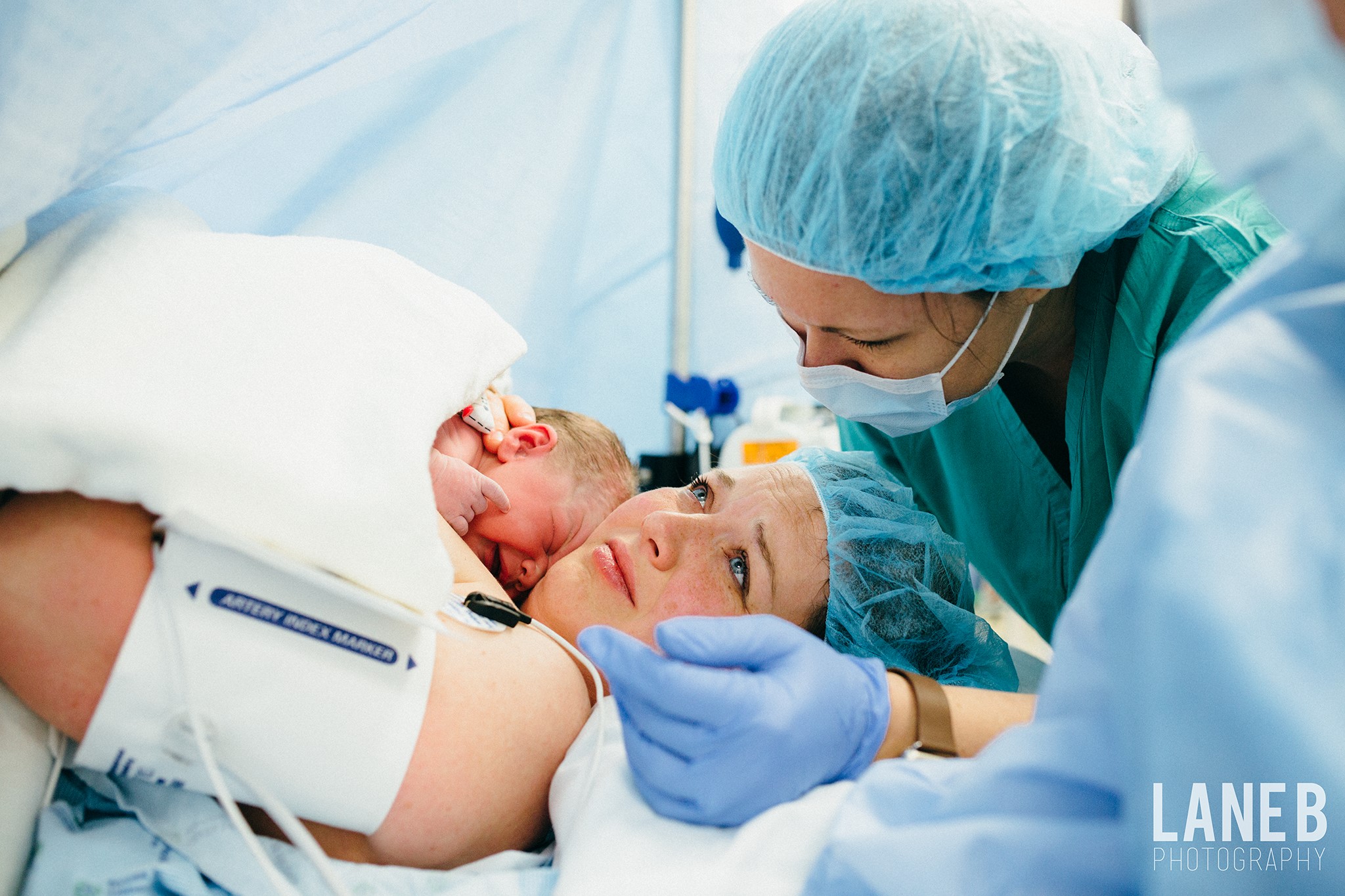 Although she tried her hardest to achieve a successful VBAC, when her birth didn't go as planned her midwife stayed by her side the entire time they were in the operating room. www.lanebphotography.com