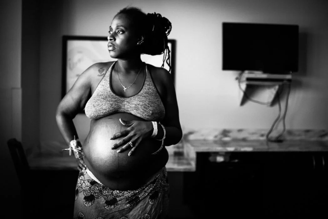 "Waiting for Her Wife and Twins" - by Melissa Pickett The edit here is really beautful. The highlights on her face and the deep shadows on her belly really make the photo multi dimensional. 