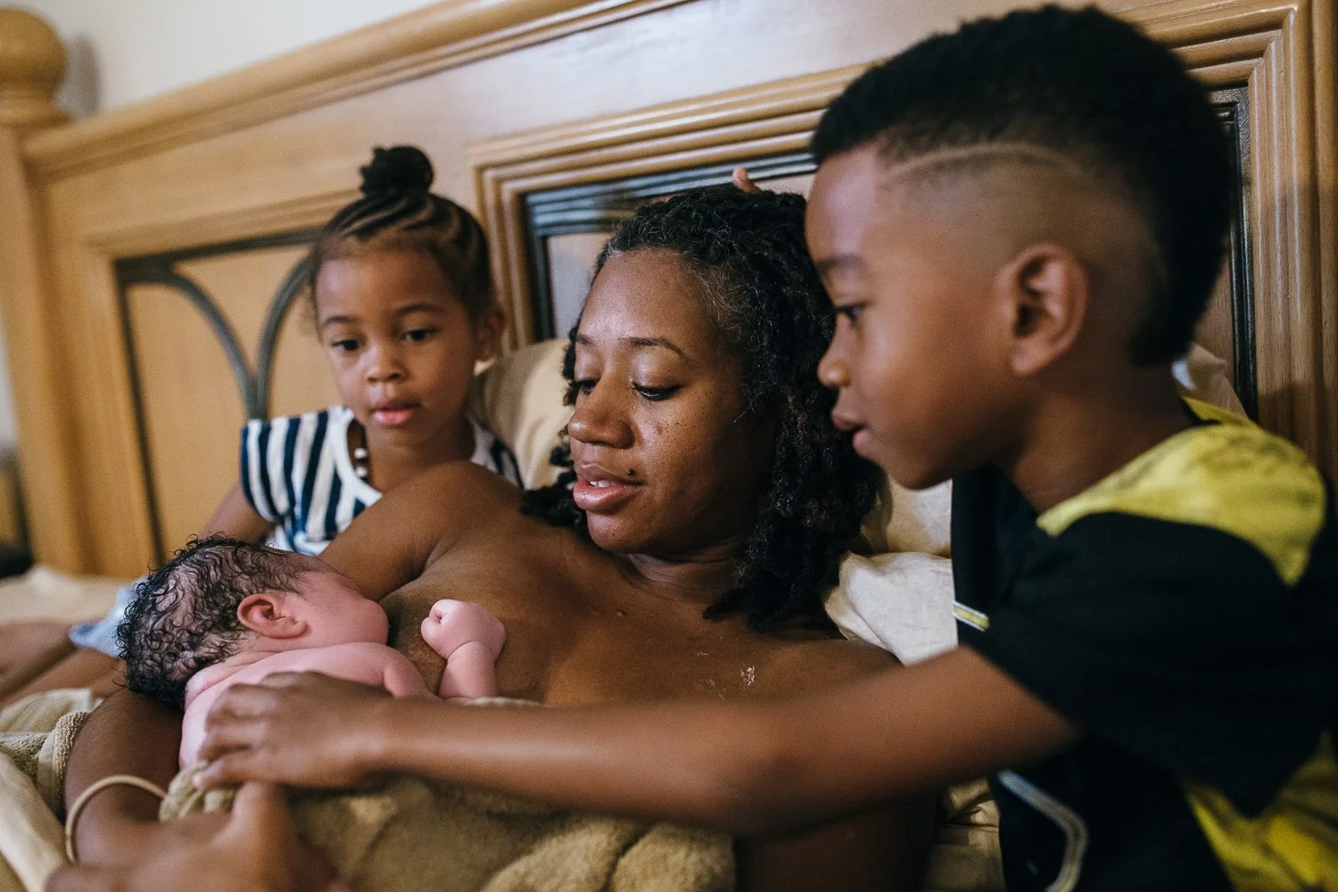 Lane B Photography / www.lanebphotography.com This family felt that it was important to include their children every step of the way through the pregnancy. Once this surprise little sister was born, they eagerly climbed up on the bed to be with mom as she nursed for the first time.
