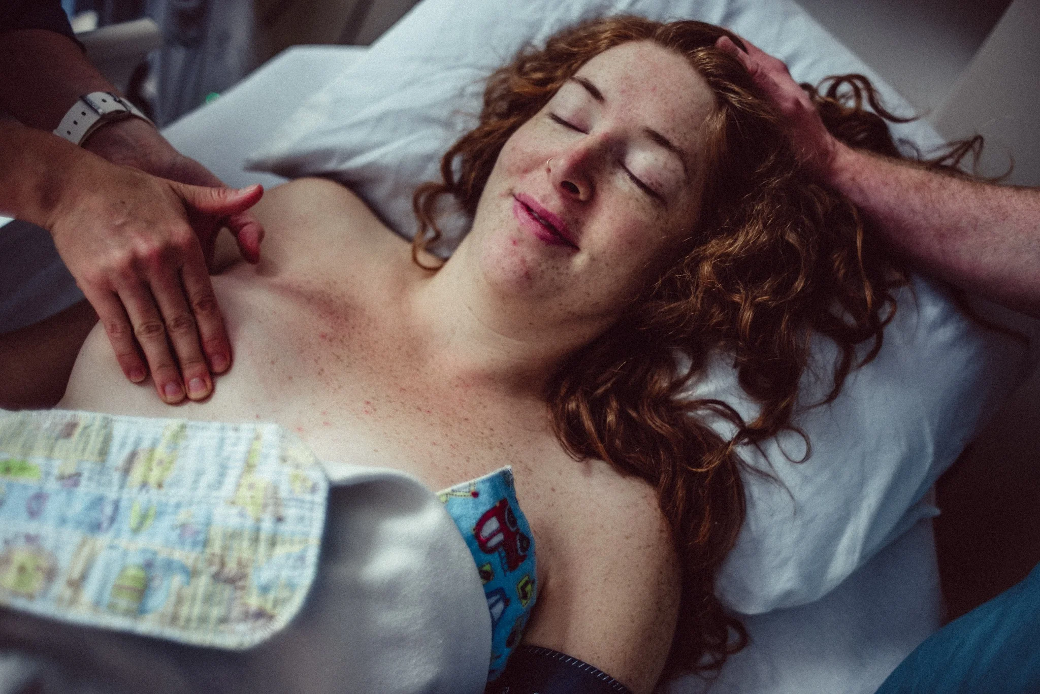 Elliana Allon, artful photos of birth + life / www.instagram.com/elliana_allon This beautiful first-time mother got to meet her son 2 months earlier than expected, due to pre-eclampsia. And so, this is her breastfeeding situation, in the minutes after her cesarean. Her midwife palpates her breasts, preparing them for hand expressing colostrum into tiny syringes that will be taken to her son in the NICU. Sweet little flannel pads lay upon her breasts, also to be taken back to her son, with her scent. She is tired, hungry, sore and drowsy from medication and right now, she needs every spare hand she can get, to help her achieve her goals. This is breastfeeding.