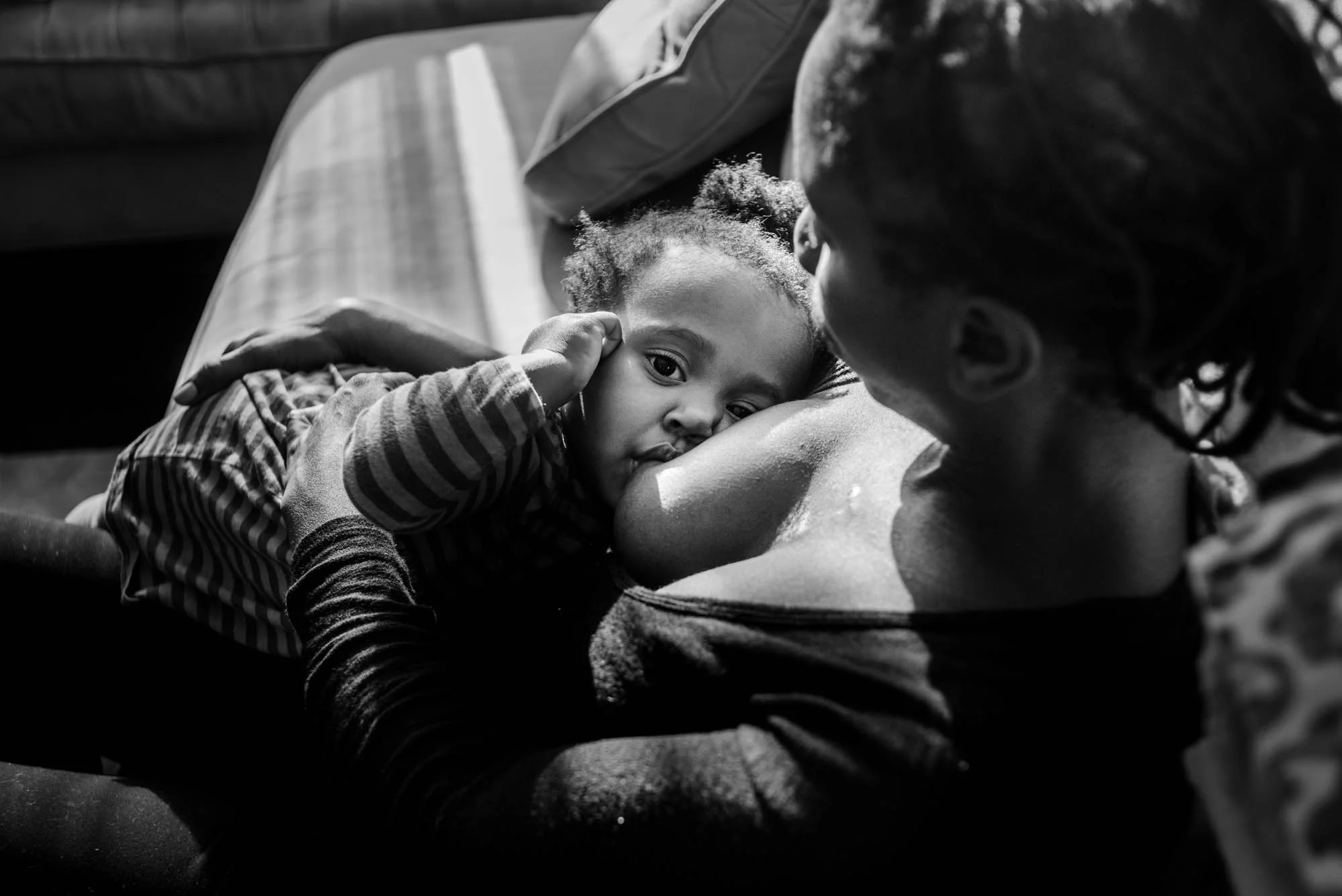 Slice of Love Photography / www.Sliceoflovephotography.com This 40-something single mom by choice had called me to document a day with her 16 month old. Being a single mom is hard, and her little girl is full of spunk and definitely keeps mom on her toes. But when she curled up in mom's lap there was this calm that fell upon the house, and the strength of this mom and the love she had for her daughter shined through. This is the power of breastfeeding. 