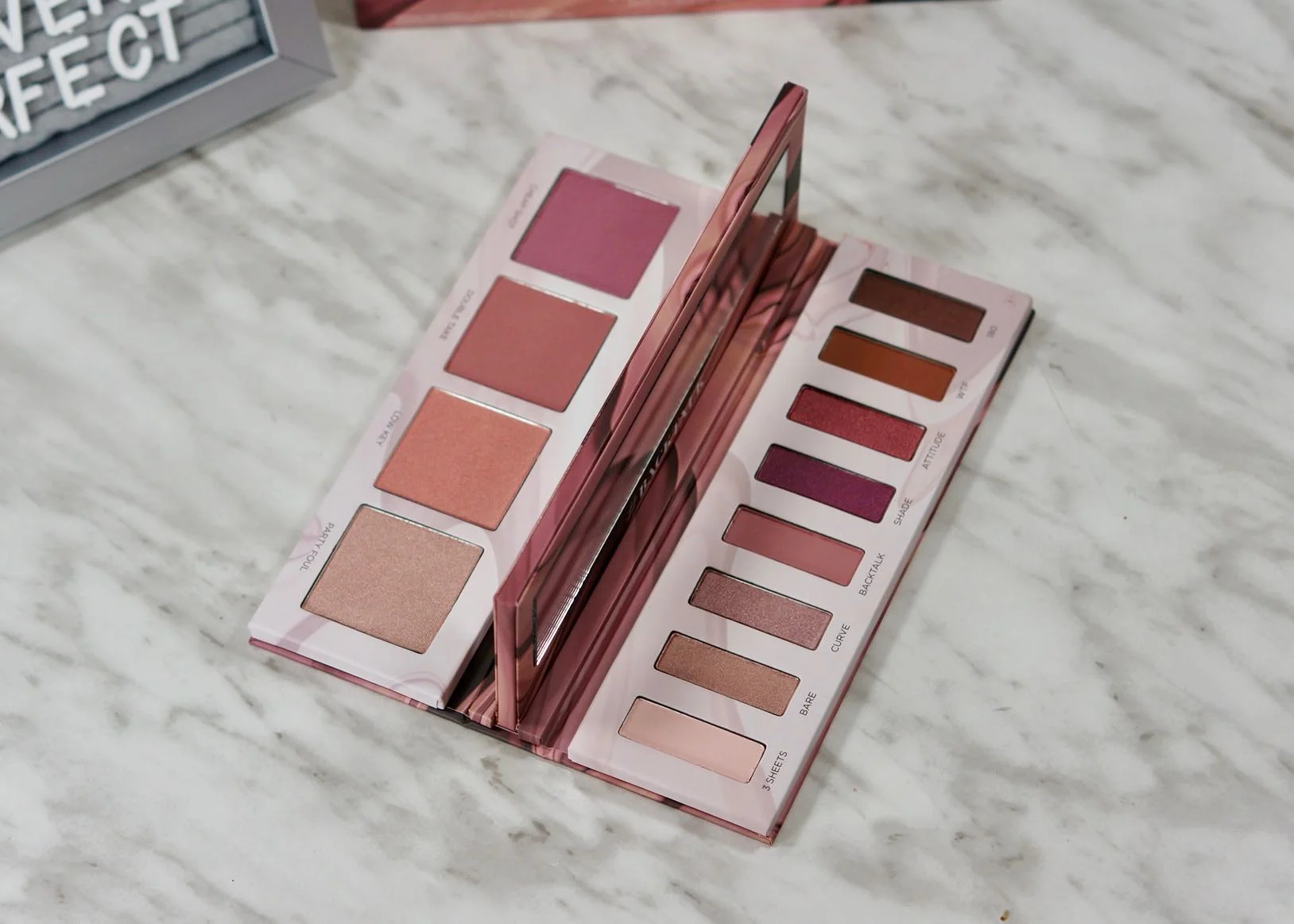 Urban Decay Backtalk palette, two sided with a mirror separating the face products from the eyeshadows.