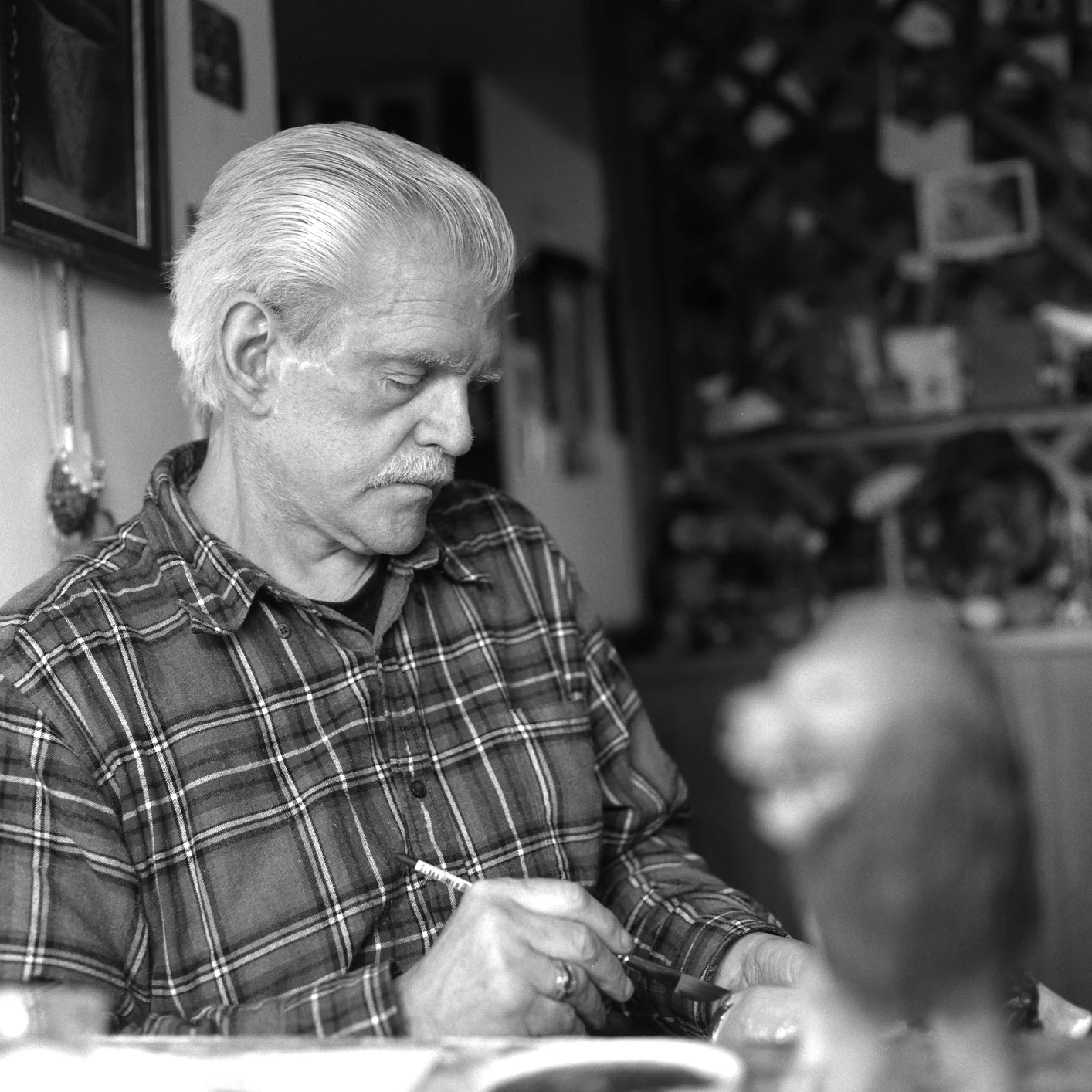 Donald working on his figurine in his home, 2015