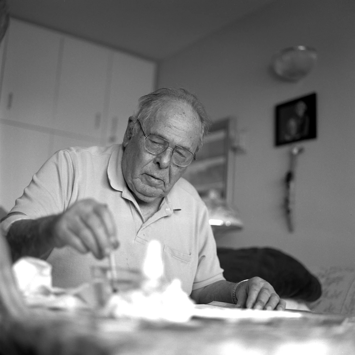 Larry working on his painting in his home, 2015
