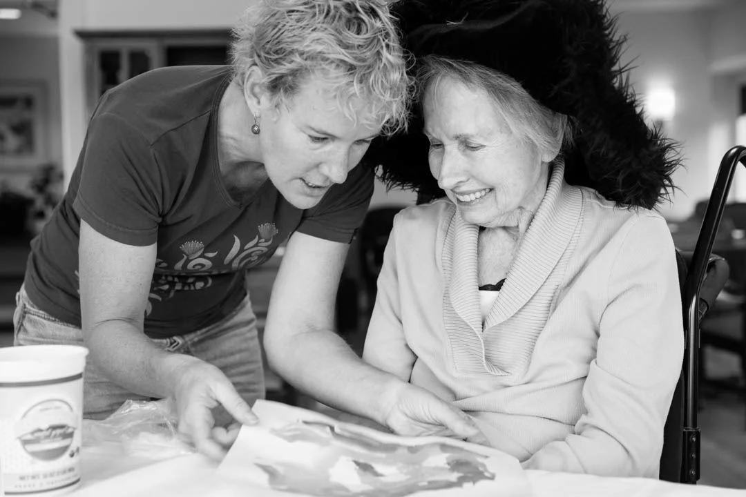 Amy helping Jane work on some painting. 