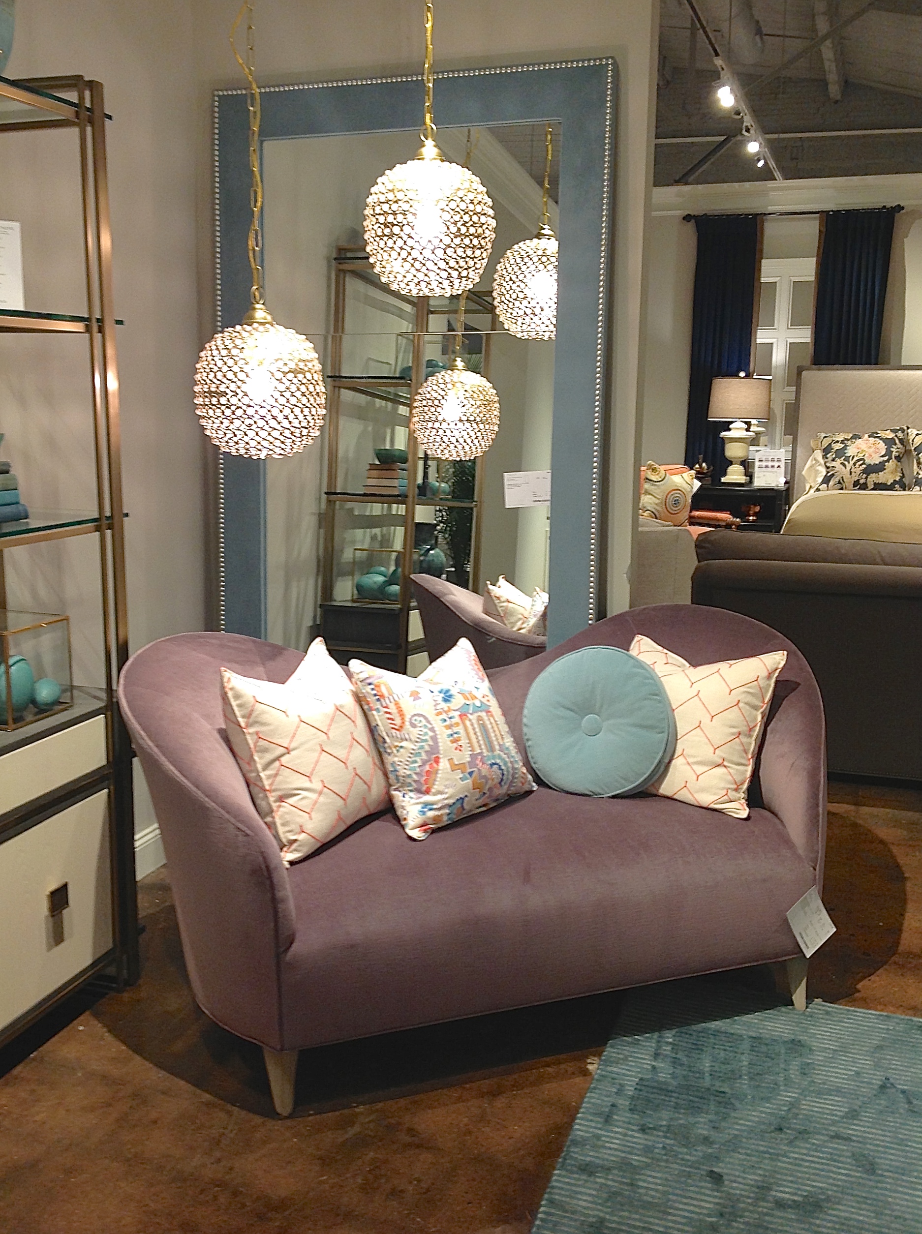 I'm loving everything about this setup - The playful lines of the sofa, the color scheme, the fun light pendants, and that beautiful mirror in the background! Customize any of these pieces with fabrics and finishes of your choice! 