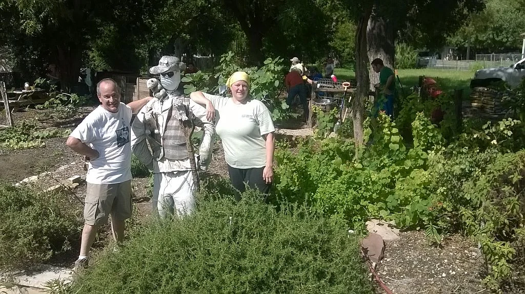 Larry Clark and Angela Hartsell, with resident garden volunteer