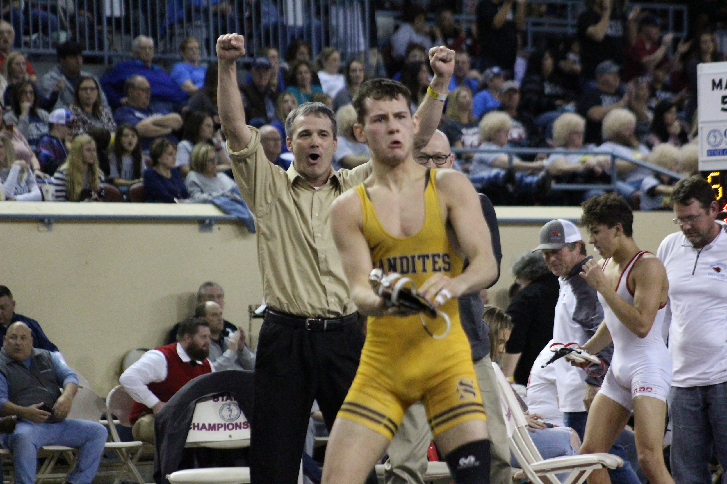  CPHS Head Coach Kelly Smith cheers on Riley Weir after winning his 2018 State Championship match. (Photo: Scott Emigh). 