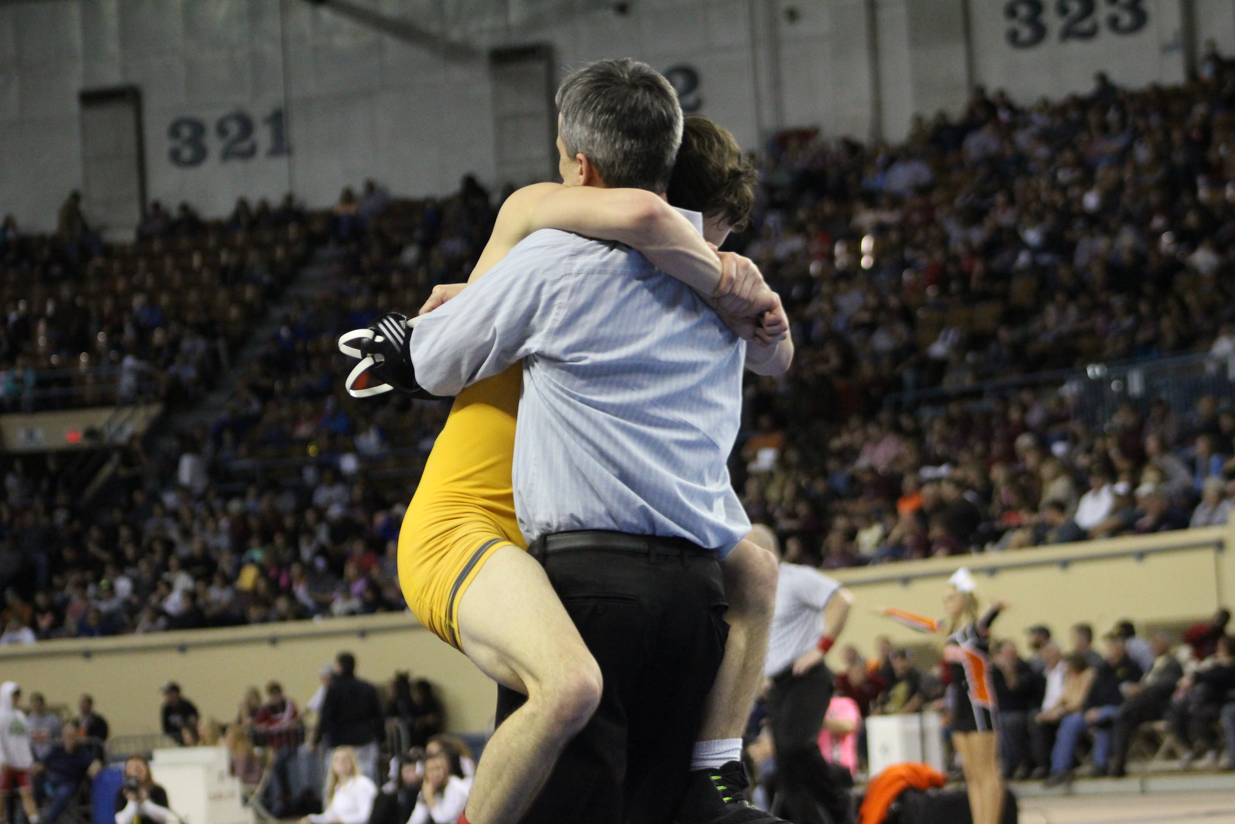  Beau Bratcher hugs his uncle, CPHS Head Wrestling Coach Kelly Smith, after winning the 2017 State Championship.&nbsp;(Photo: Scott Emigh). 