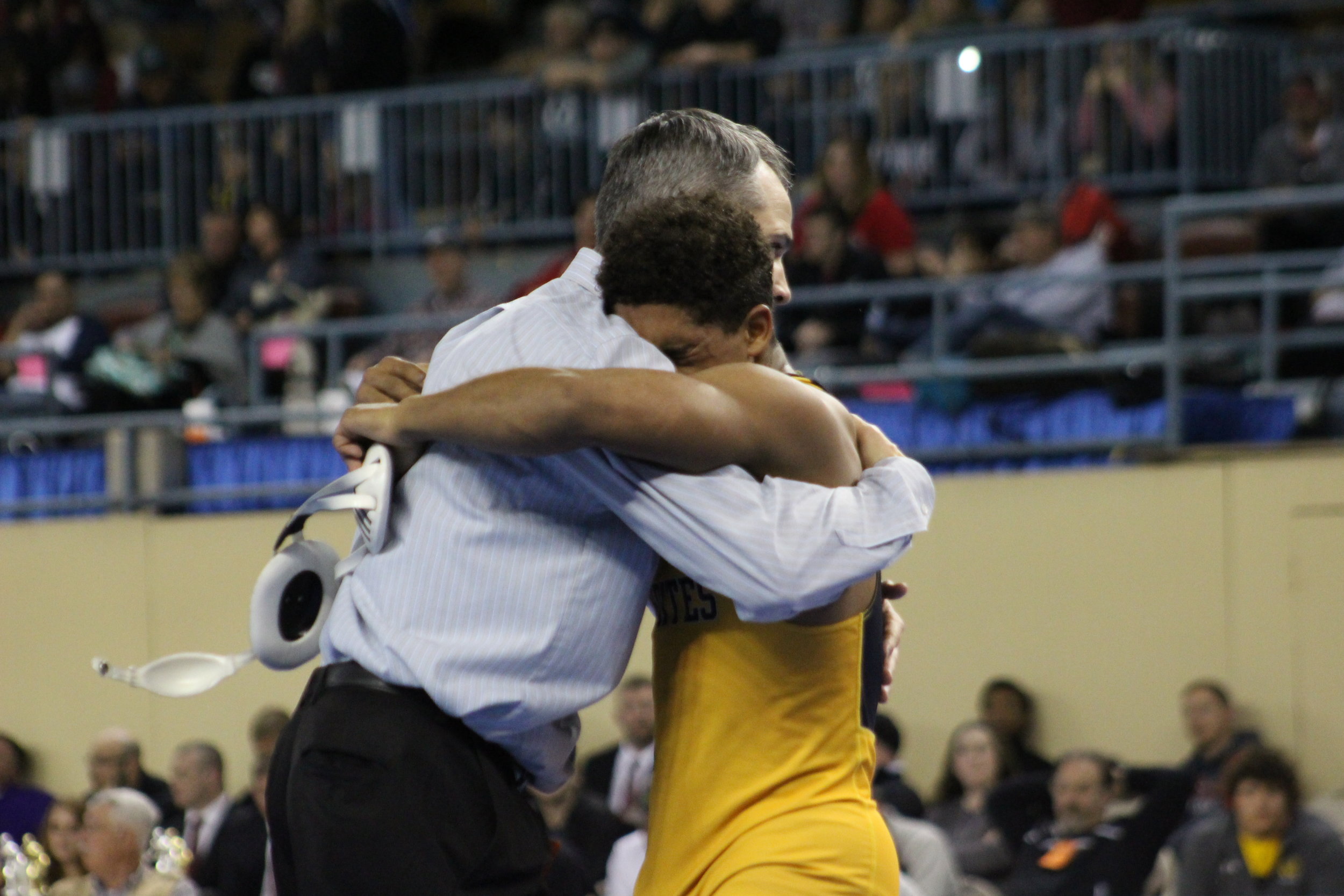  Payton Scott hugs CPHS Head Wrestling Coach Kelly Smith after winning the 2017 State Championship.&nbsp;(Photo: Scott Emigh). 