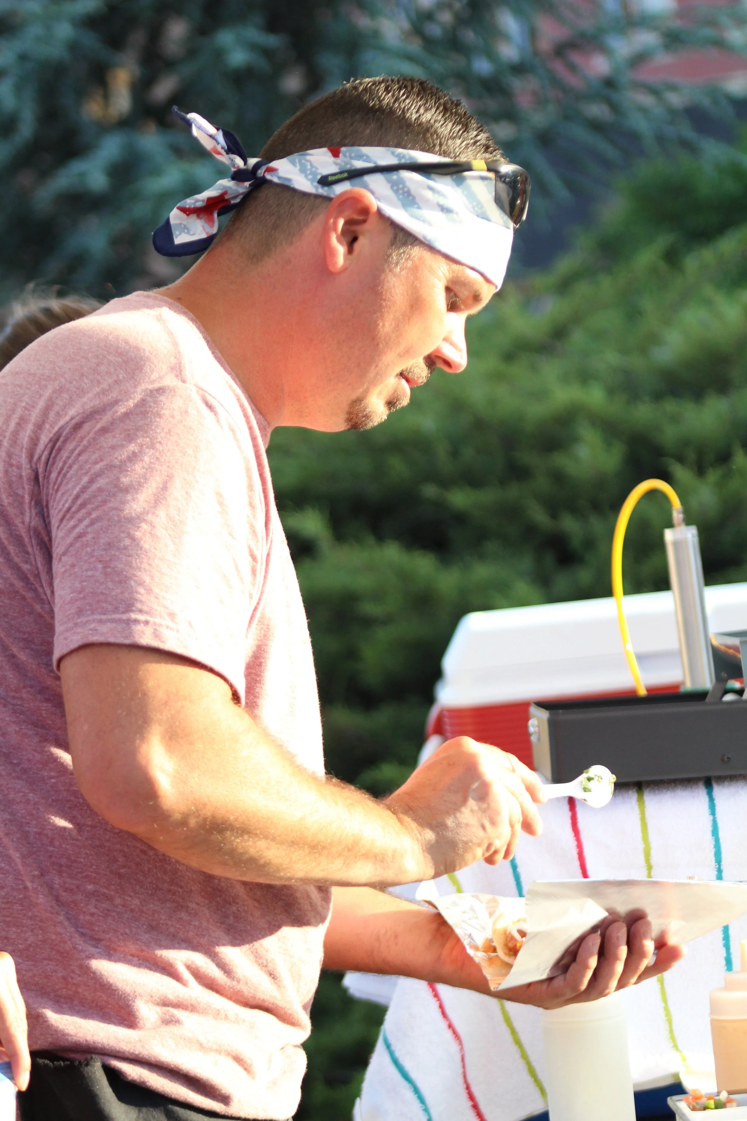  Jeremy Myers, Kingdom Concessions, serves up Sonoran hot dogs at Tuesday on the Triangle. 