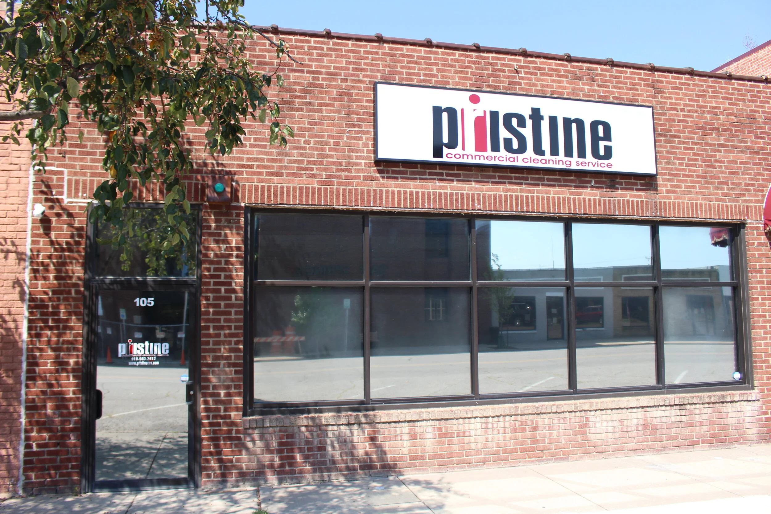 Downtown red brick storefront cleaning company in Sand Springs, Oklahoma