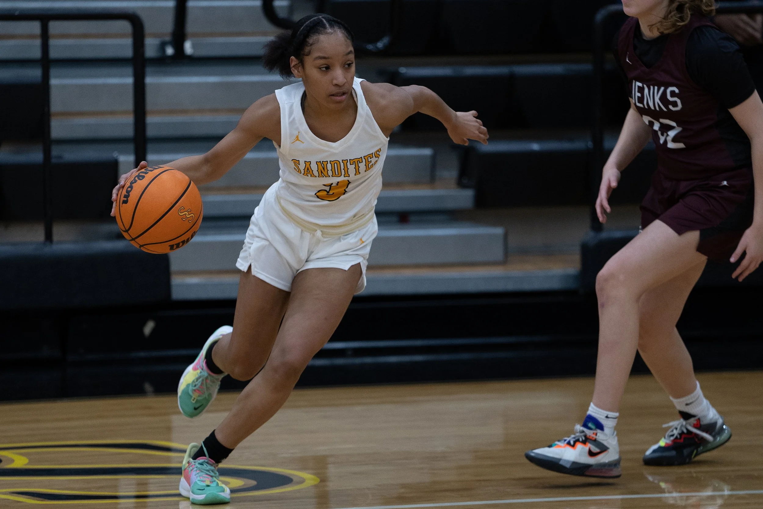 Taiona Morris dribbles past a Jenks defender