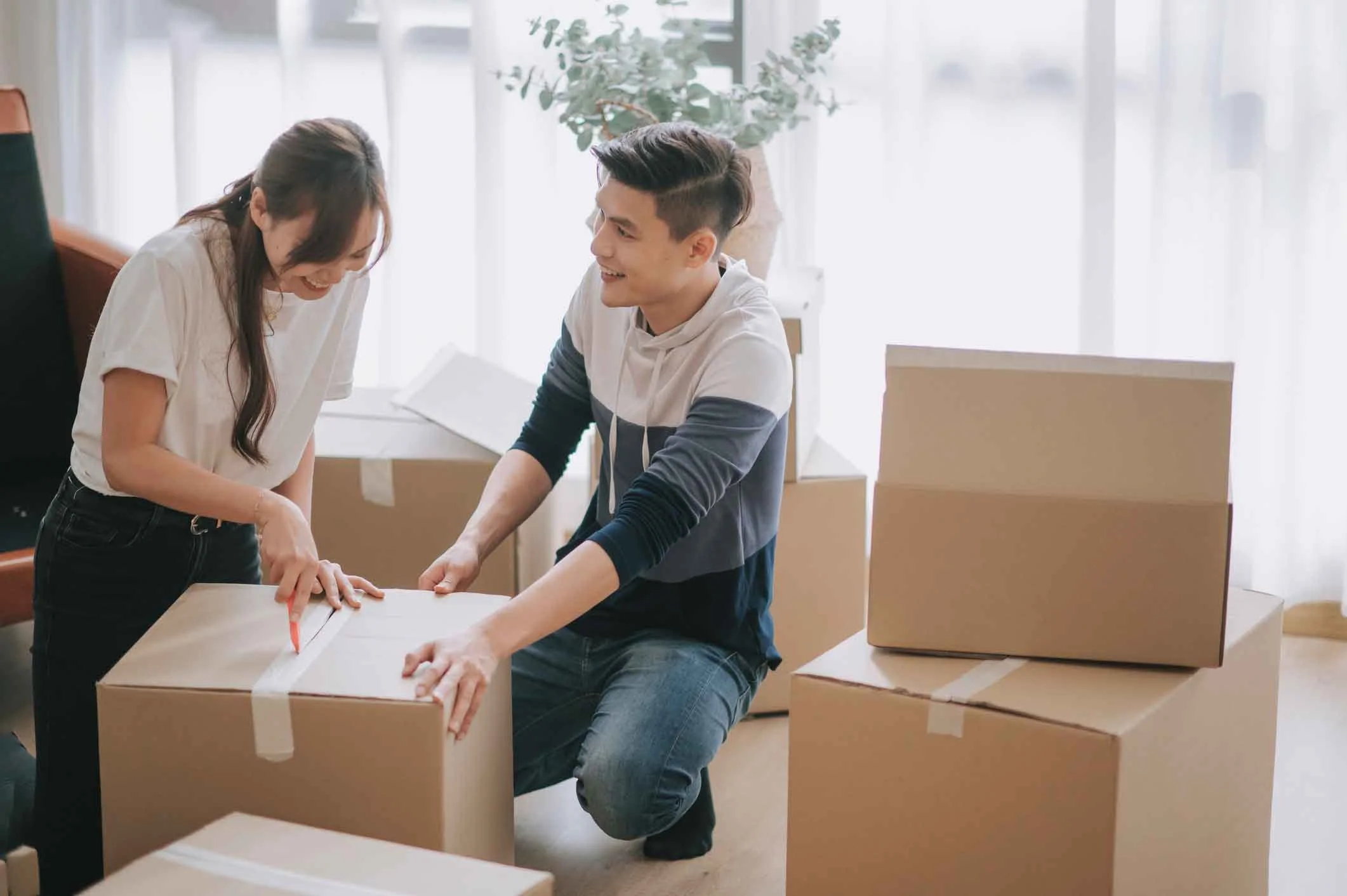Young couple packing for move.